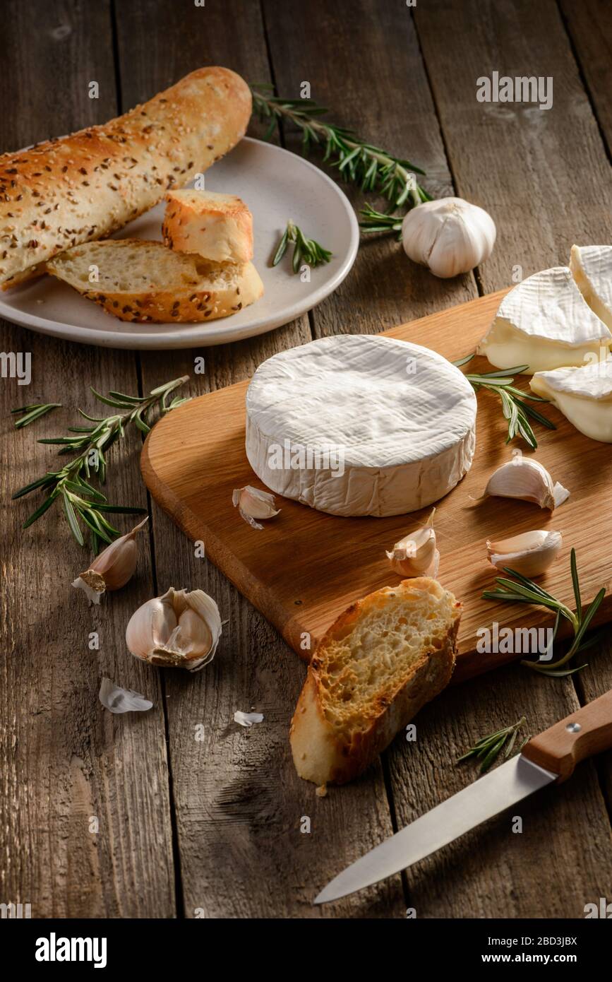 Brie cheese, garlic, rosemary and baguette bread Stock Photo Alamy