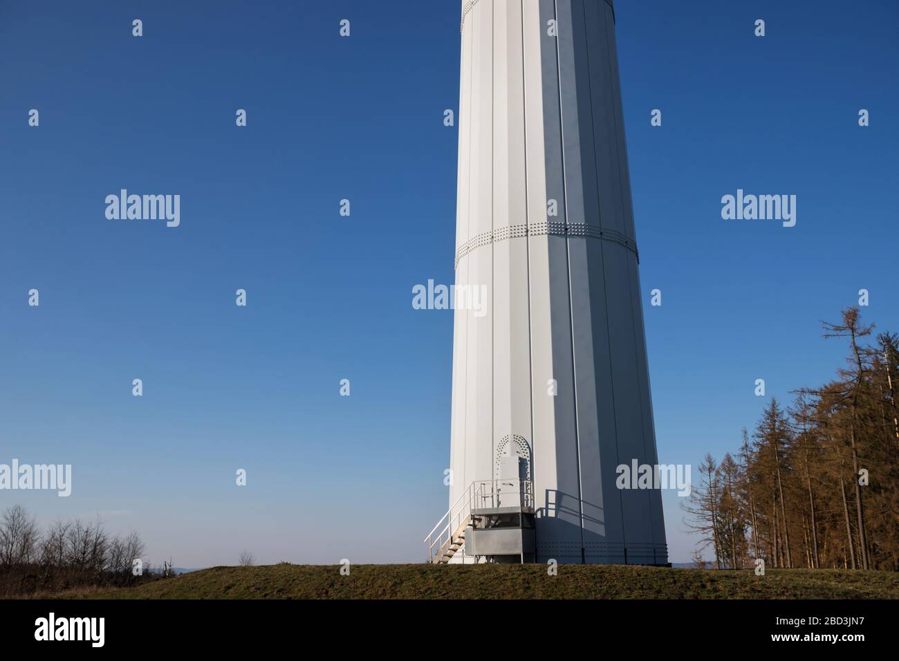 modern wind turbine column in front of the evening sun Stock Photo Alamy