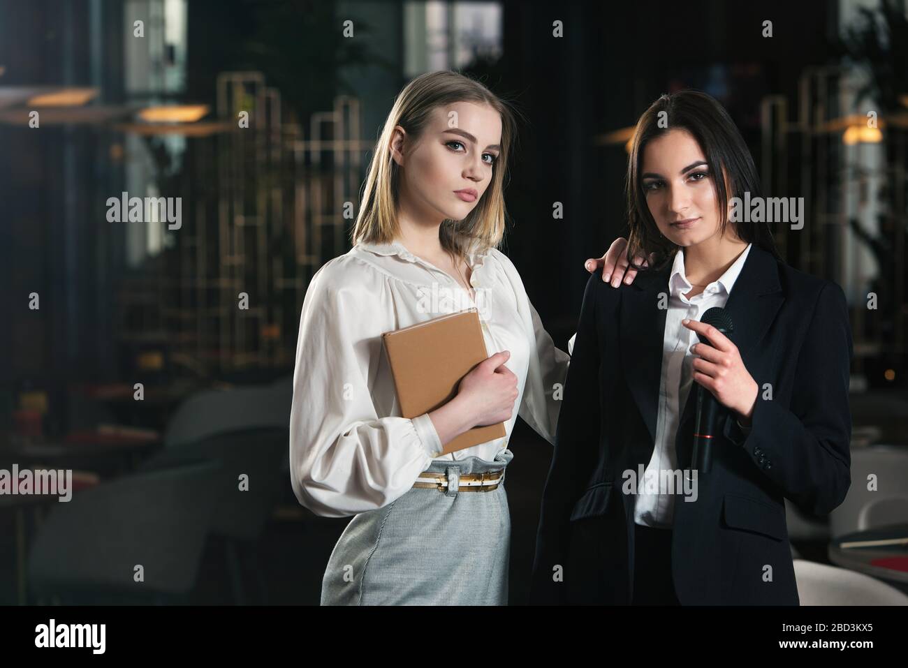 Two women standing together hi-res stock photography and images - Alamy