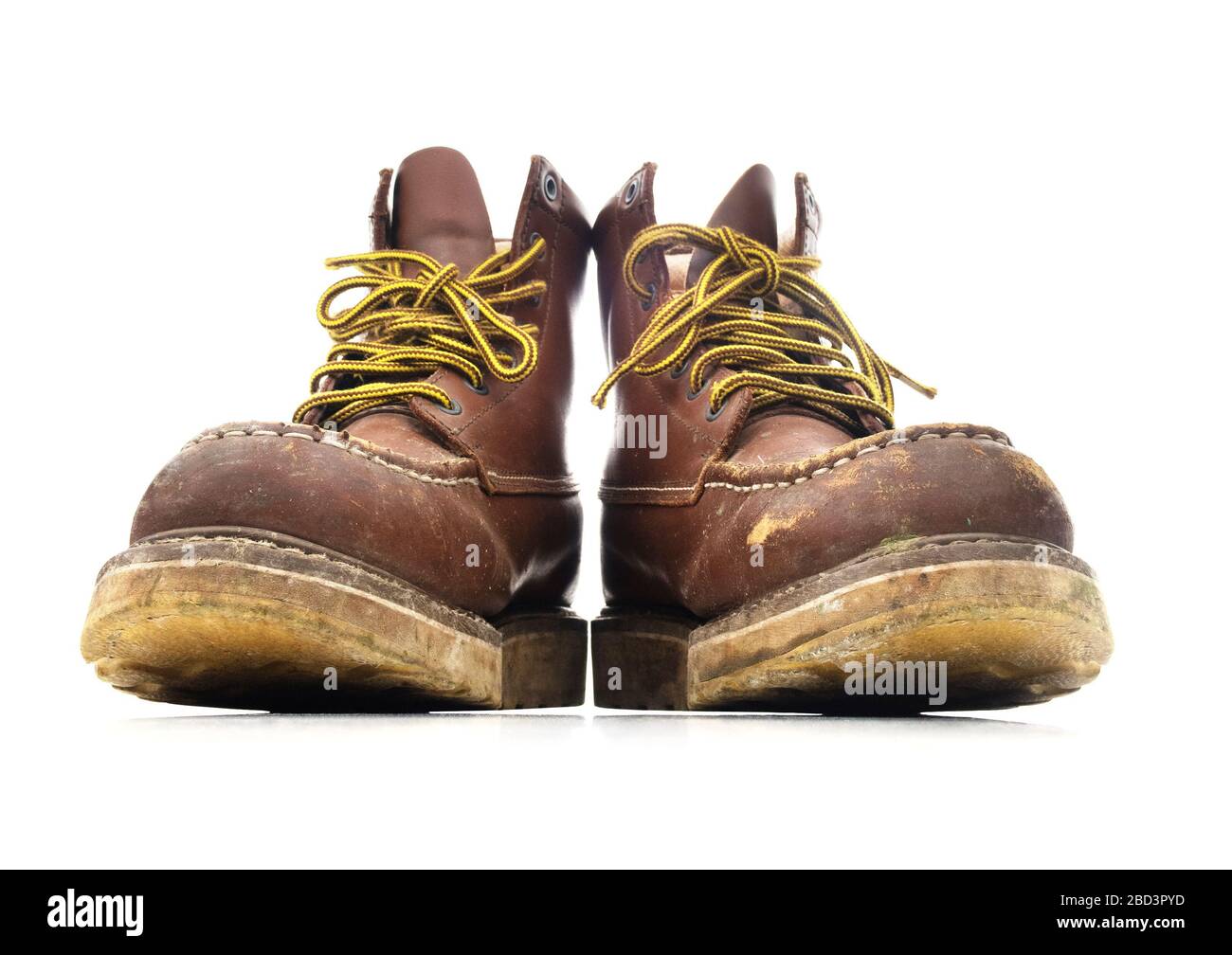 Used brown construction work boots on a white background. Stock Photo