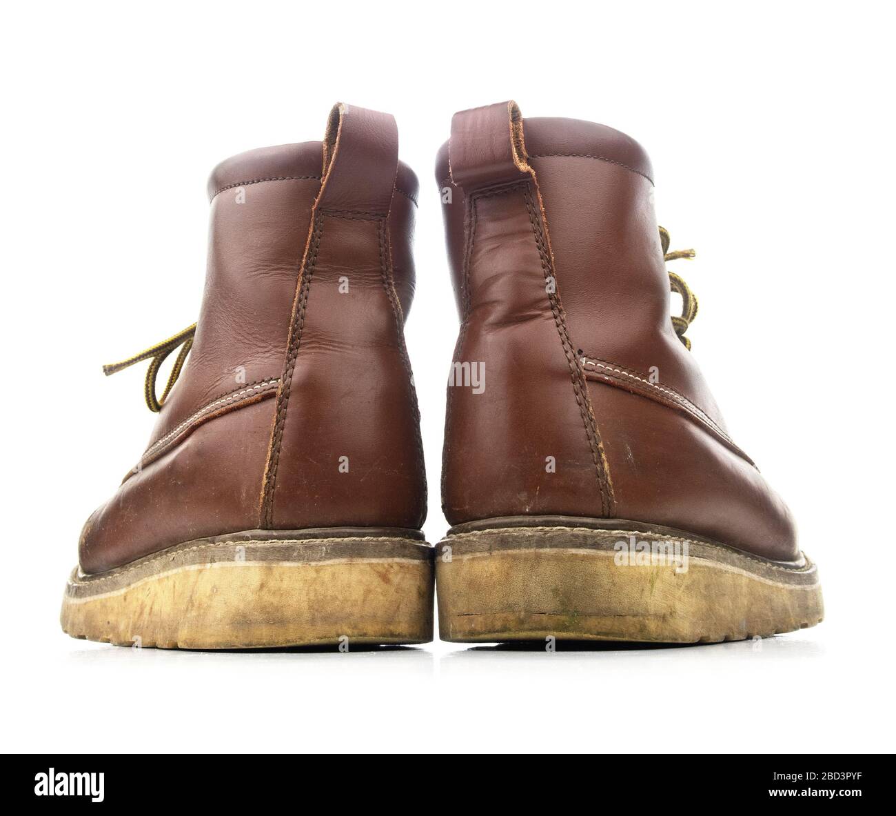 Used brown construction work boots on a white background. Stock Photo