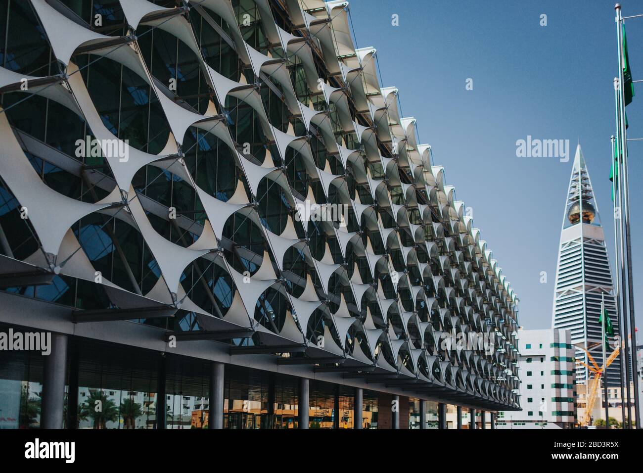Riyadh, Saudi Arabia - November 6, 2019: Perpective view of the King Fahad National Library facade towards Al Faisaliyah Tower during blue hour after Stock Photo