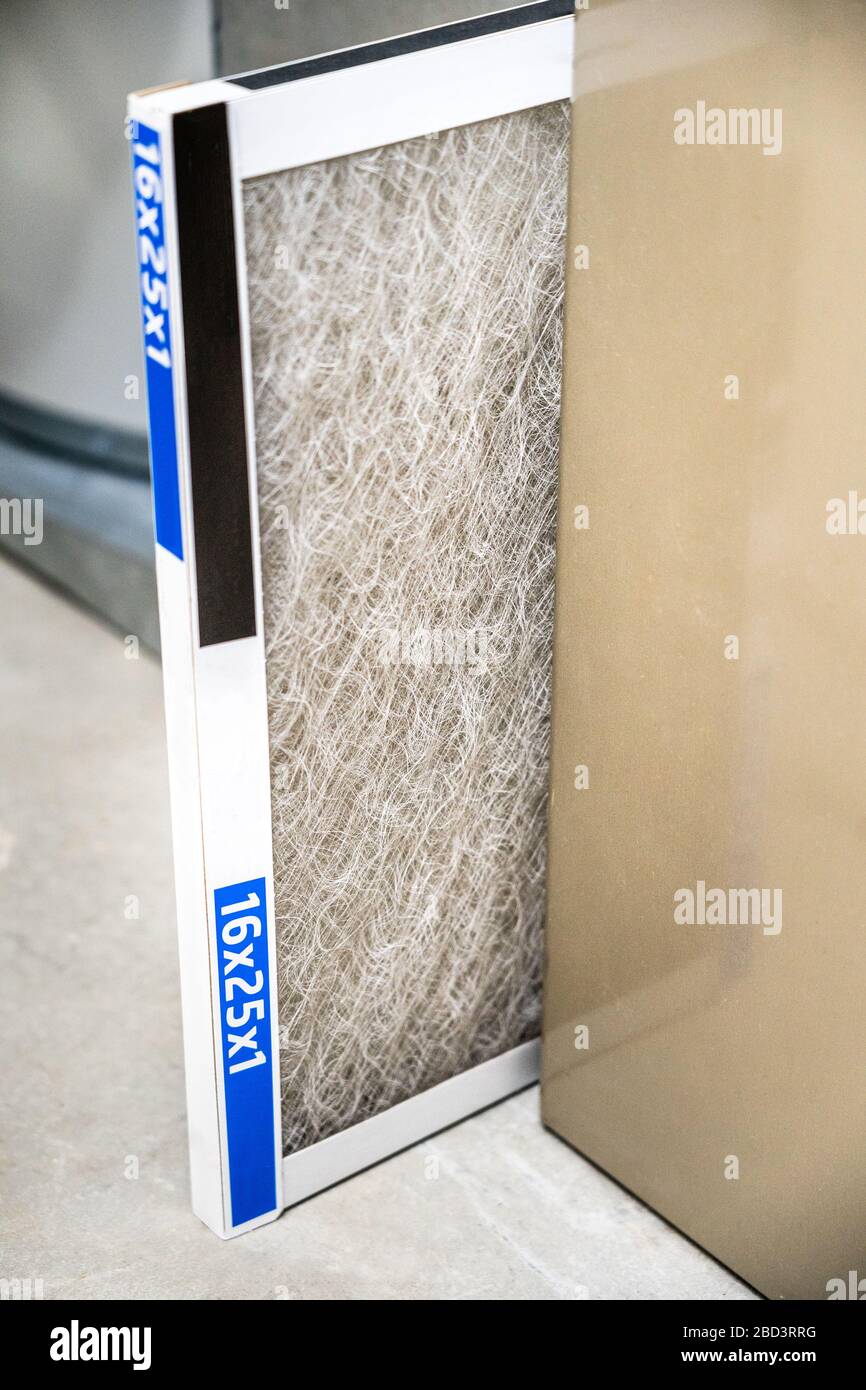 Old dirty furnace filter partially pulled out from holder Stock Photo Alamy