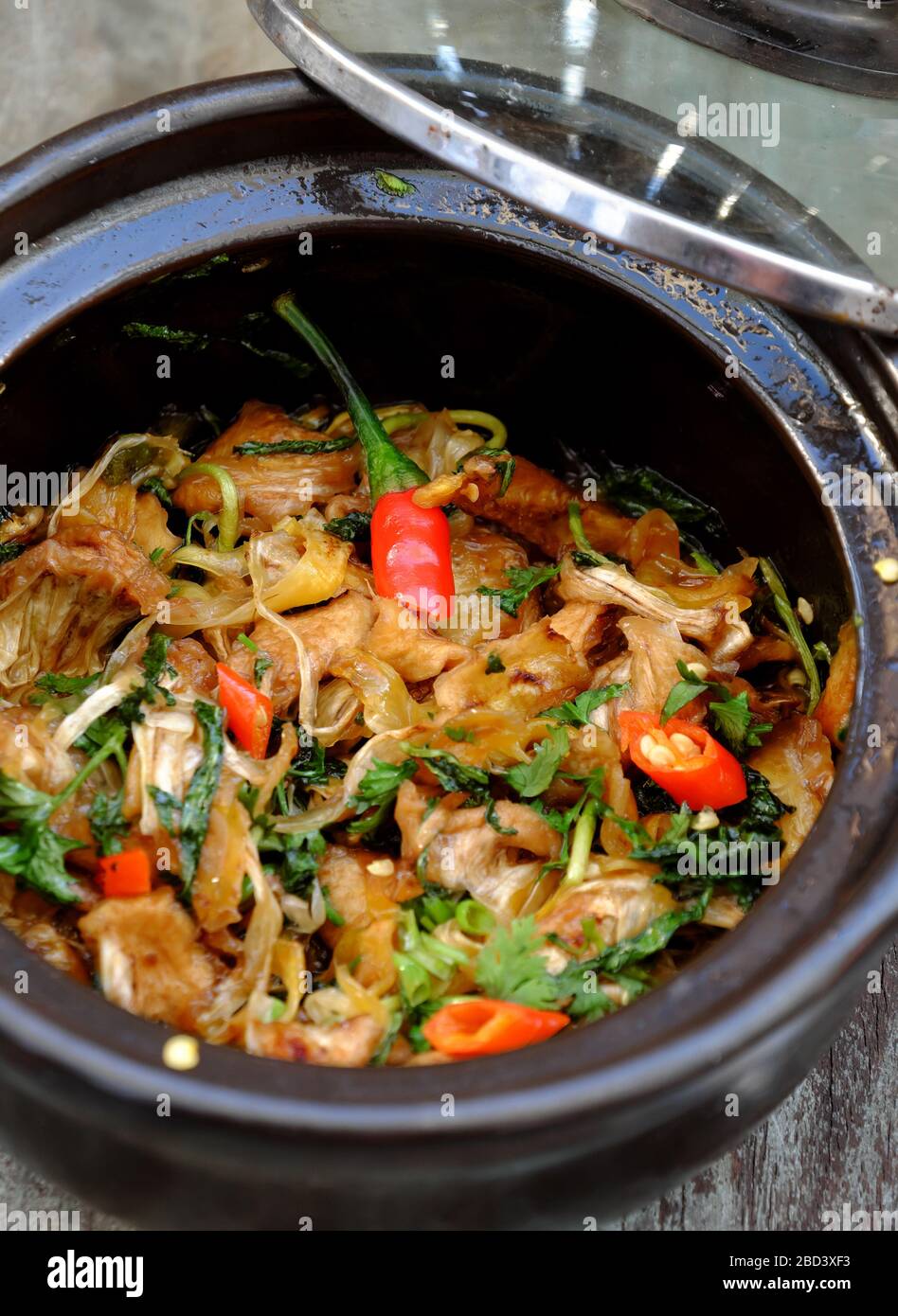 homemade Vietnamese vegan food for daily meal,edible fibre of breadfruit cook dried with sauce, laksa leaves, delicious vegetarian dish from jackfruit Stock Photo