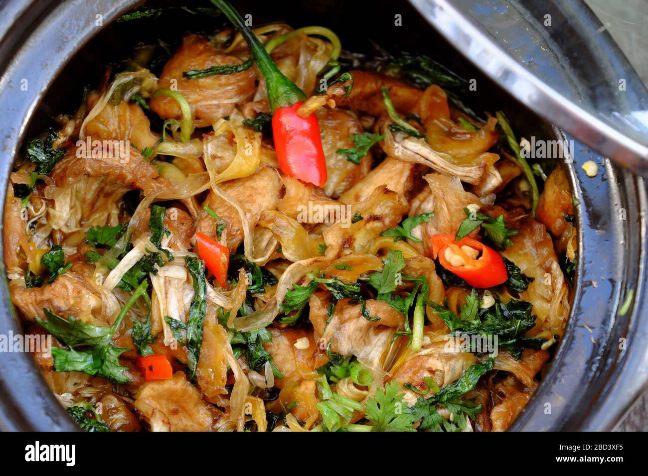 homemade Vietnamese vegan food for daily meal,edible fibre of breadfruit cook dried with sauce, laksa leaves, delicious vegetarian dish from jackfruit Stock Photo