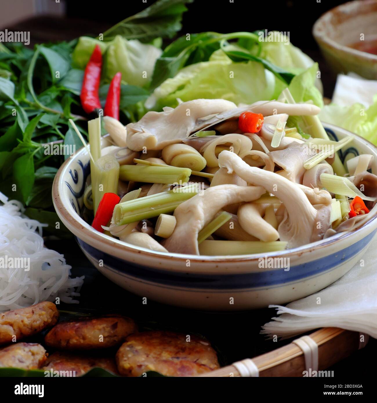 Close up plate of white straw mushroom that steamed with chilli and citronella with salad vegetables for vegan meal at Vietnam Stock Photo