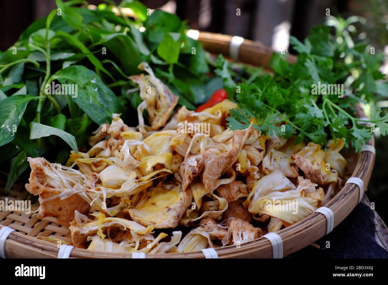 High view tray raw material of homemade Vietnamese vegan food for daily meal, edible fibre of breadfruit cook dried with sauce and laksa leaves, delic Stock Photo