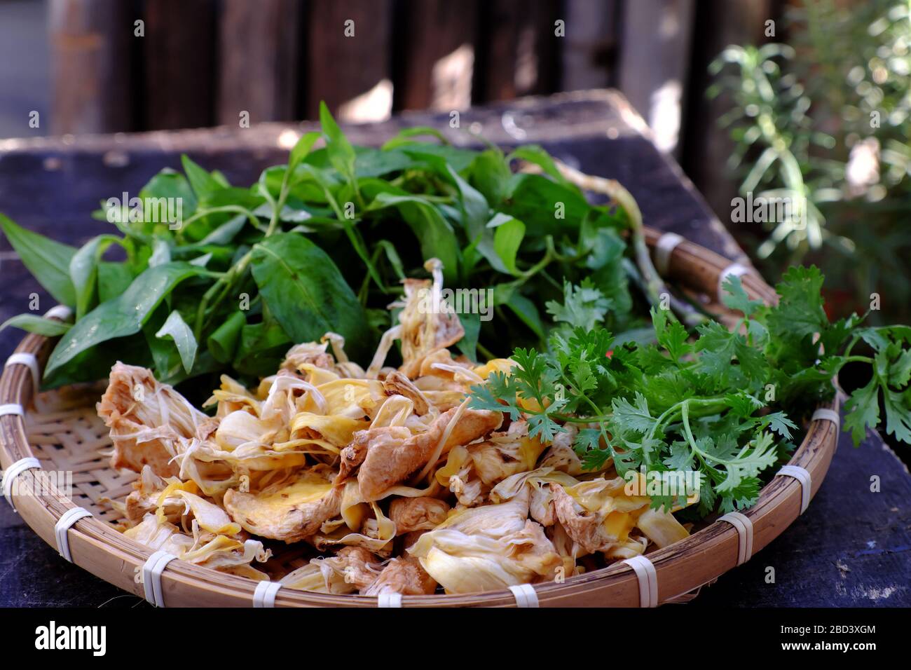 High view tray raw material of homemade Vietnamese vegan food for daily meal, edible fibre of breadfruit cook dried with sauce and laksa leaves, delic Stock Photo