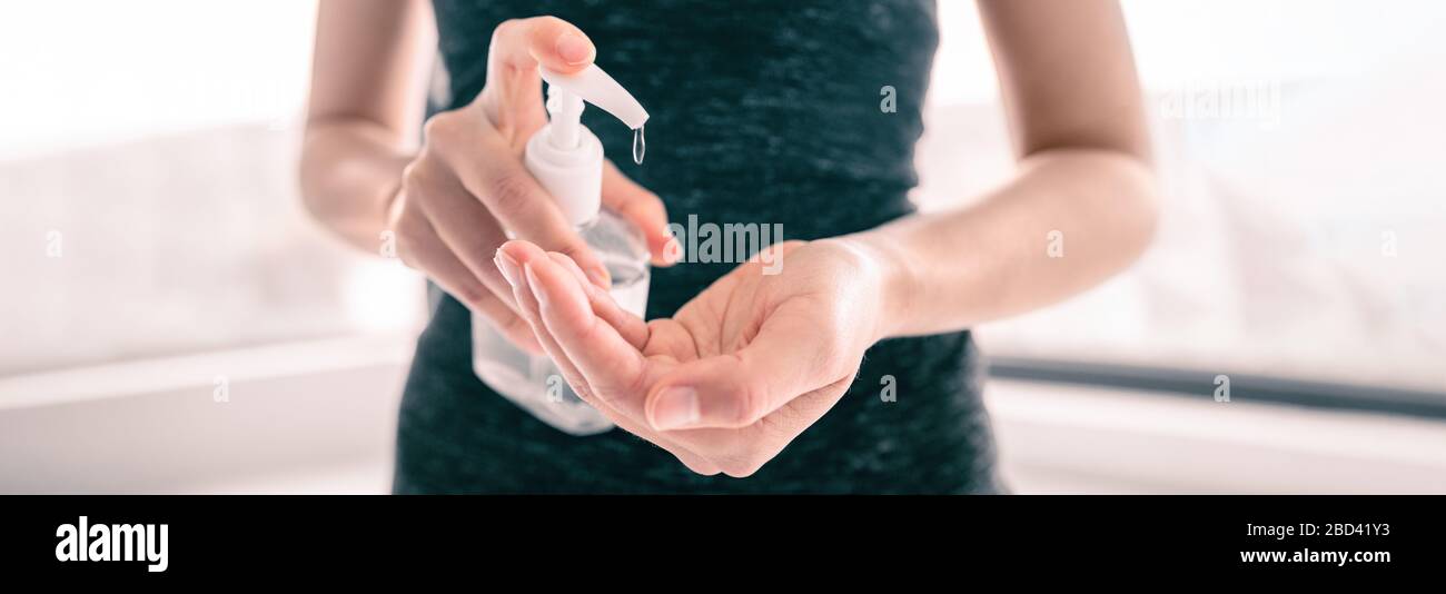 COVID-19 Hand sanitizer rubbing hands woman applying sanitizing gel liquid clean personal hygiene coronavirus pervention at home. Sanitiser bottle banner header. Stock Photo