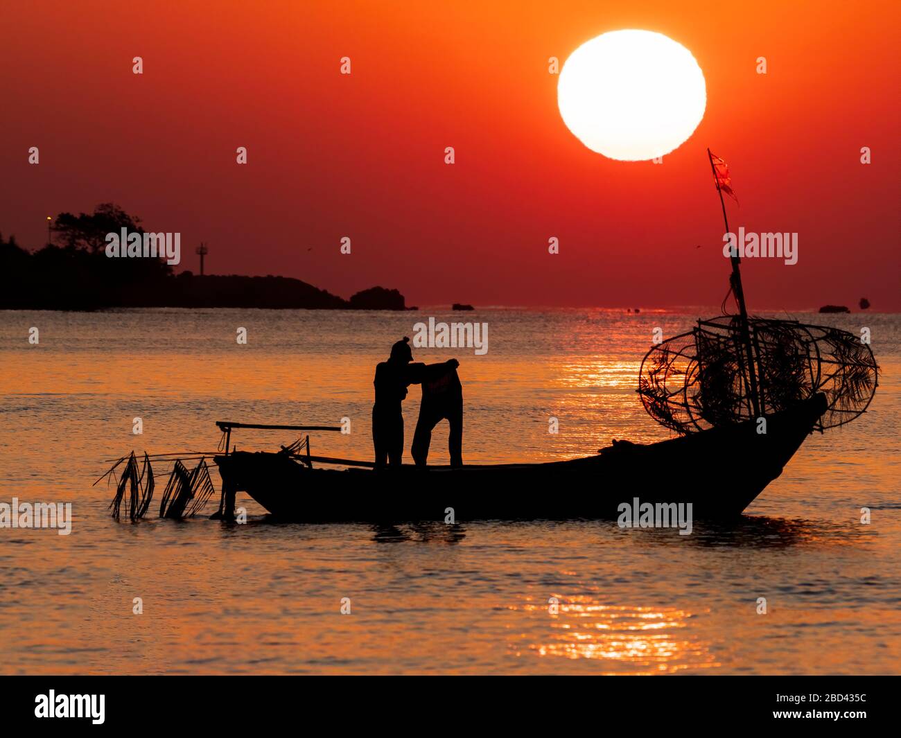 Silhouette of a traditional Thai fishing boat with a background of the ...