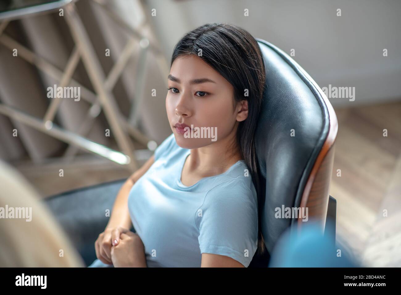 Pretty asian young woman with long hair looking serious Stock Photo
