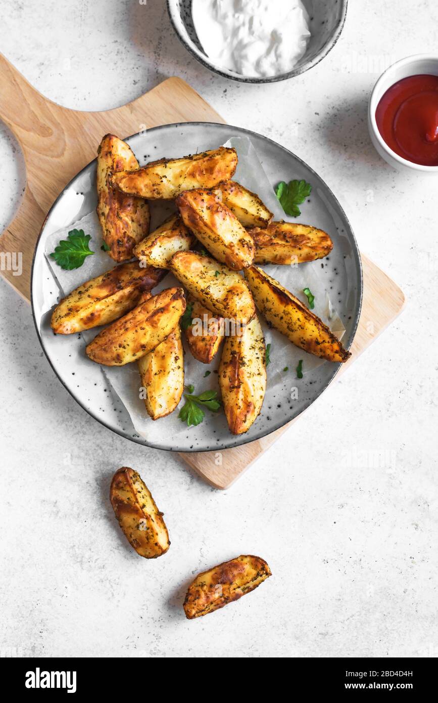 Baked Potato Wedges With Cheese And Herbs And Sauces Homemade Organic Vegetable Vegan Vegetarian Potato Wedges Snack Food Meal Top View Stock Photo Alamy Baked Potato Wedges With Cheese And Herbs And Sauces Homemade Organic Vegetable Vegan Vegetarian Potato Wedges Snack Food Meal Top View Stock Photo Alamy
