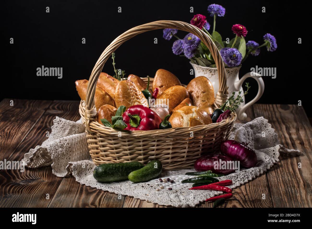 Pies with meat in the wicker basket on a black background Stock Photo