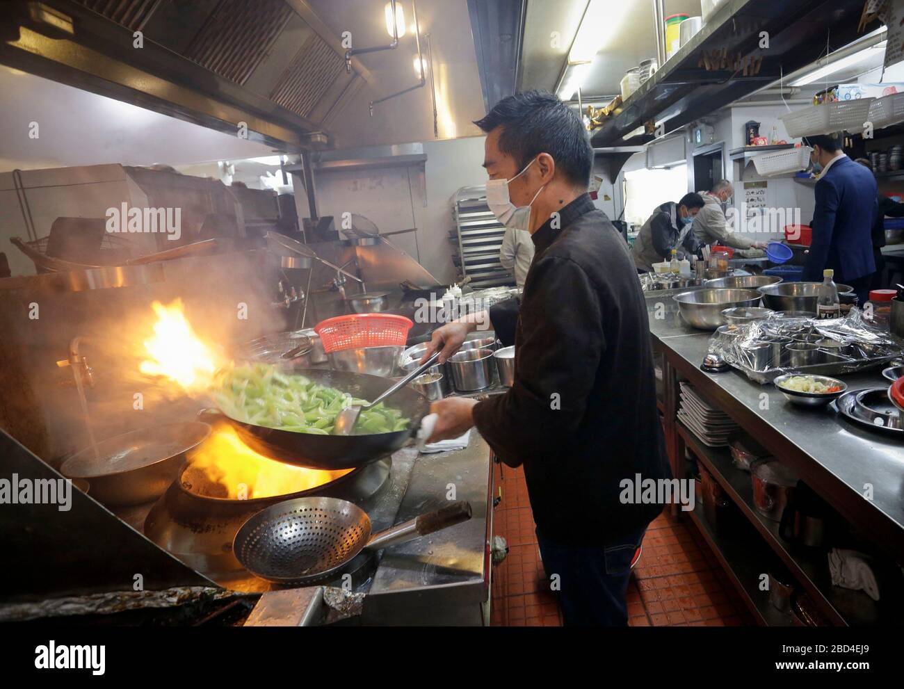 Vancouver, Canada. 6th Apr, 2020. A chef prepares food inside the kitchen for the frontline workers of Vancouver General Hospital at a Chinese restaurant in Vancouver, Canada, April 6, 2020. The Canadian government is recruiting volunteers to support frontline healthcare workers to combat the COVID-19 crisis. Some local Chinese restaurants donated meals to the frontline healthcare workers fighting COVID-19. Credit: Liang Sen/Xinhua/Alamy Live News Stock Photo