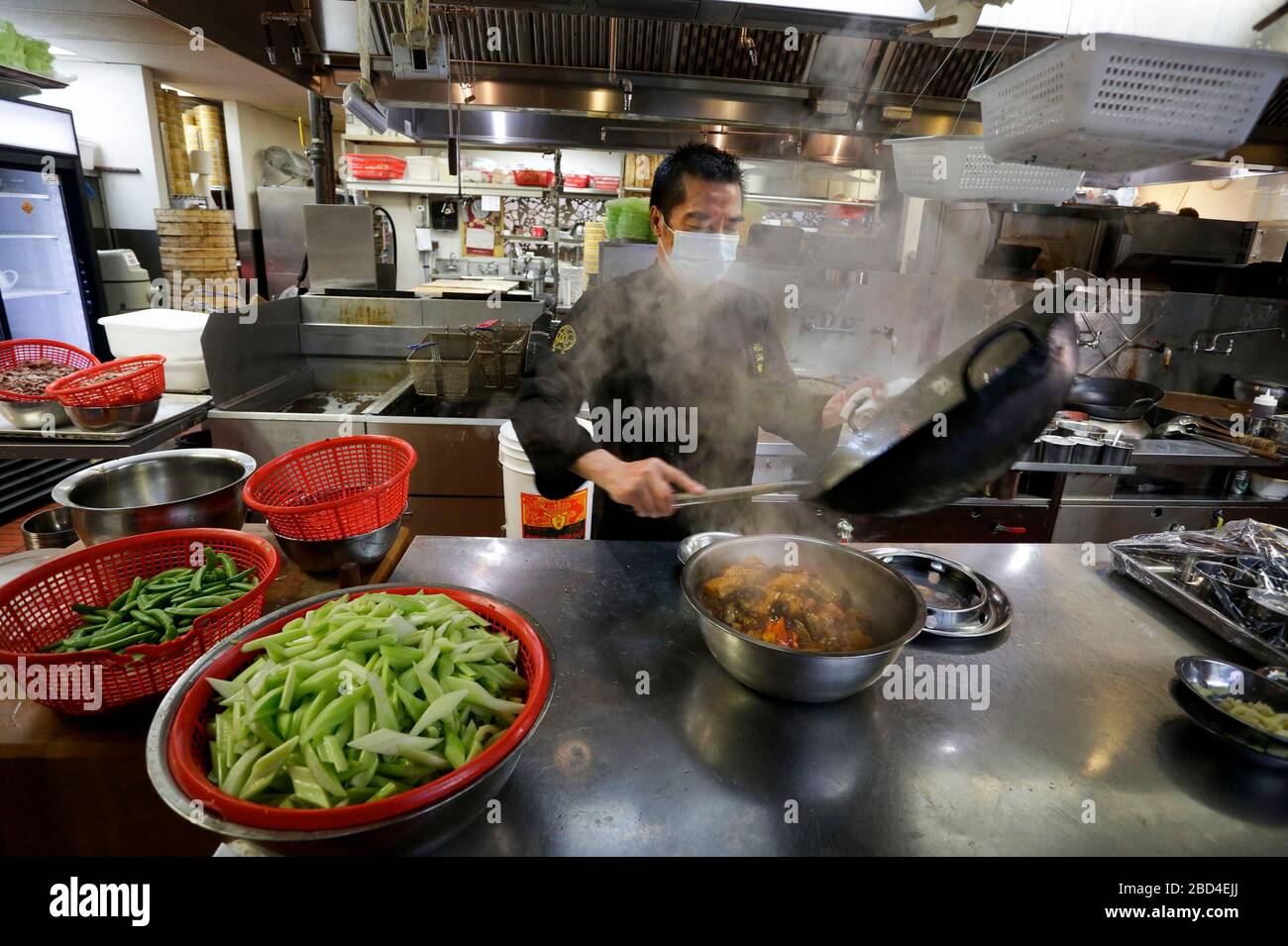 Vancouver, Canada. 6th Apr, 2020. A chef prepares food inside the kitchen for the frontline workers of Vancouver General Hospital at a Chinese restaurant in Vancouver, Canada, April 6, 2020. The Canadian government is recruiting volunteers to support frontline healthcare workers to combat the COVID-19 crisis. Some local Chinese restaurants donated meals to the frontline healthcare workers fighting COVID-19. Credit: Liang Sen/Xinhua/Alamy Live News Stock Photo