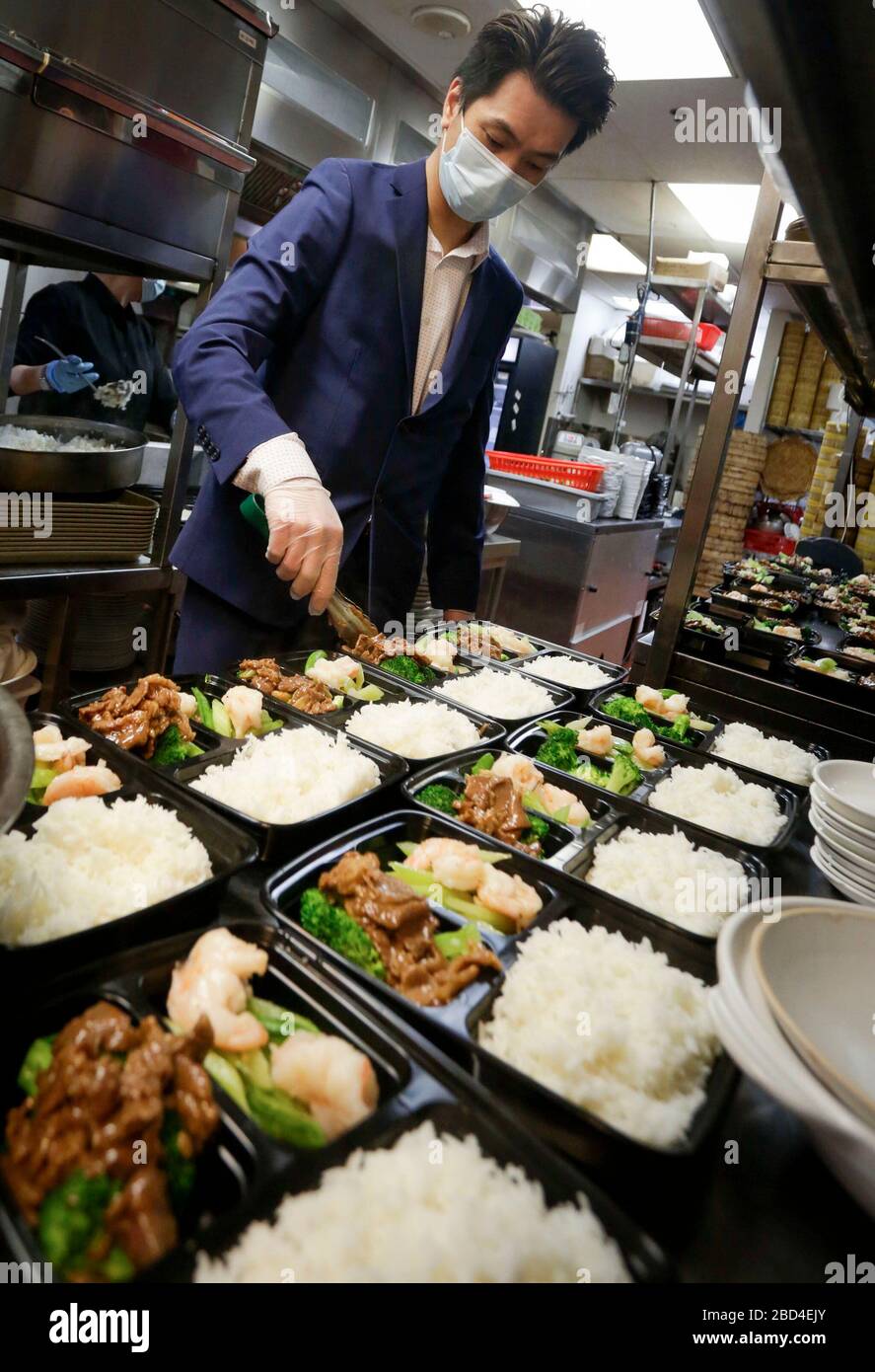 Vancouver, Canada. 6th Apr, 2020. A staff member of a Chinese restaurant prepares meal boxes inside the kitchen for the frontline workers of Vancouver General Hospital in Vancouver, Canada, April 6, 2020. The Canadian government is recruiting volunteers to support frontline healthcare workers to combat the COVID-19 crisis. Some local Chinese restaurants donated meals to the frontline healthcare workers fighting COVID-19. Credit: Liang Sen/Xinhua/Alamy Live News Stock Photo