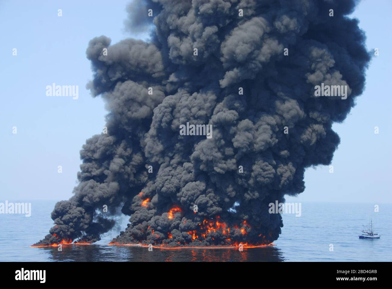 A controlled burn of oil from the Deepwater Horizon/BP oil spill sends towers of fire hundreds of feet into the air over the Gulf of Mexico ca. June 9, 2010 Stock Photo