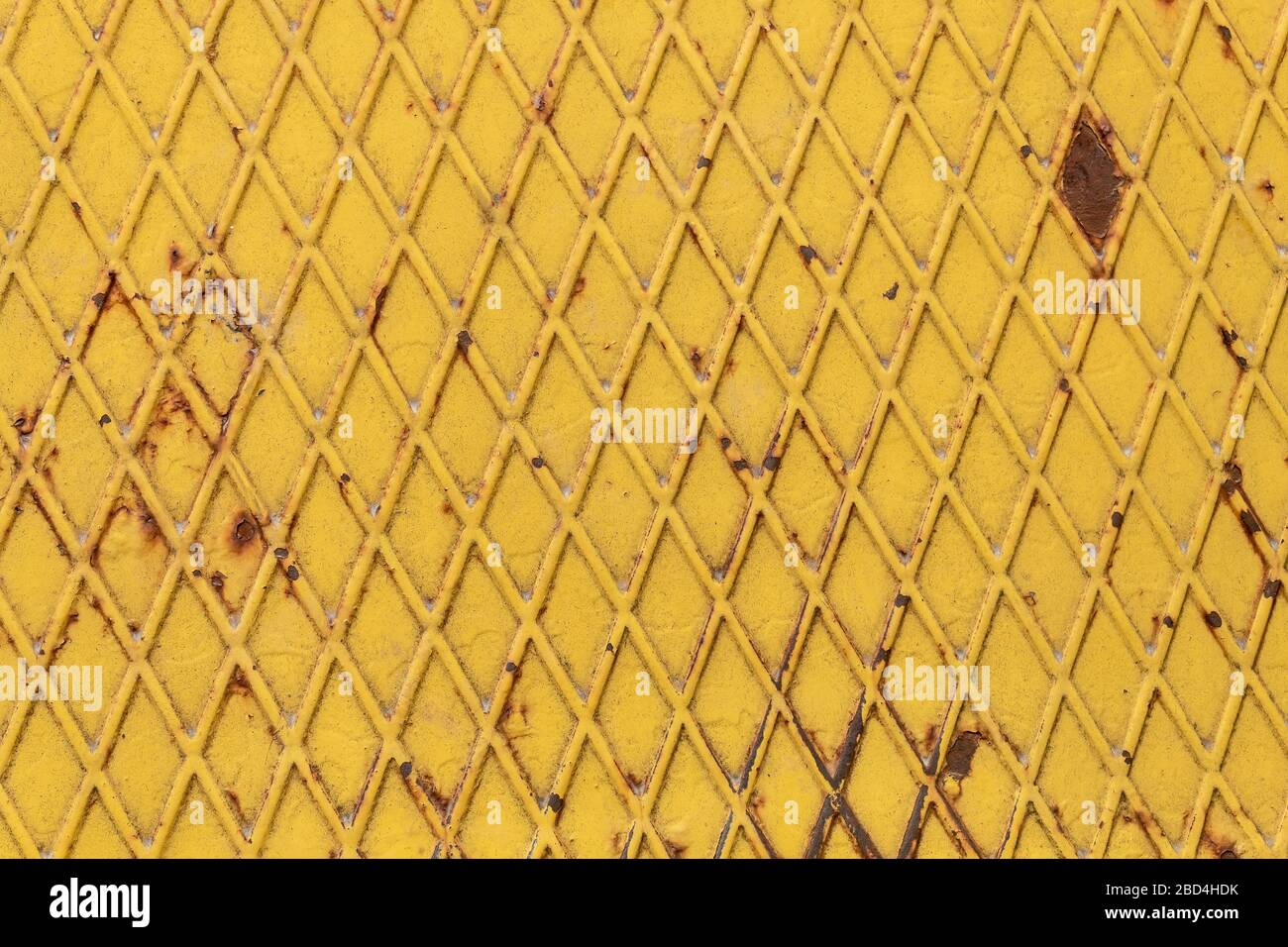 Yellow Painted Metal With Repeating Pattern Stock Photo