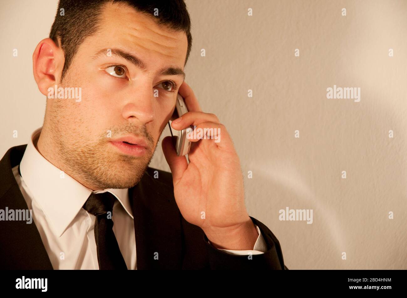 Young executive using mobile phone. Stock Photo