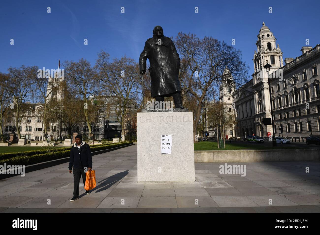 A sign saying 'get well soon Boris' displayed on the Winston Churchill statue in Parliament Square, Westminster, London, as Prime Minister Boris Johnson remains in hospital following his admission on Sunday with continuing coronavirus symptoms. Stock Photo