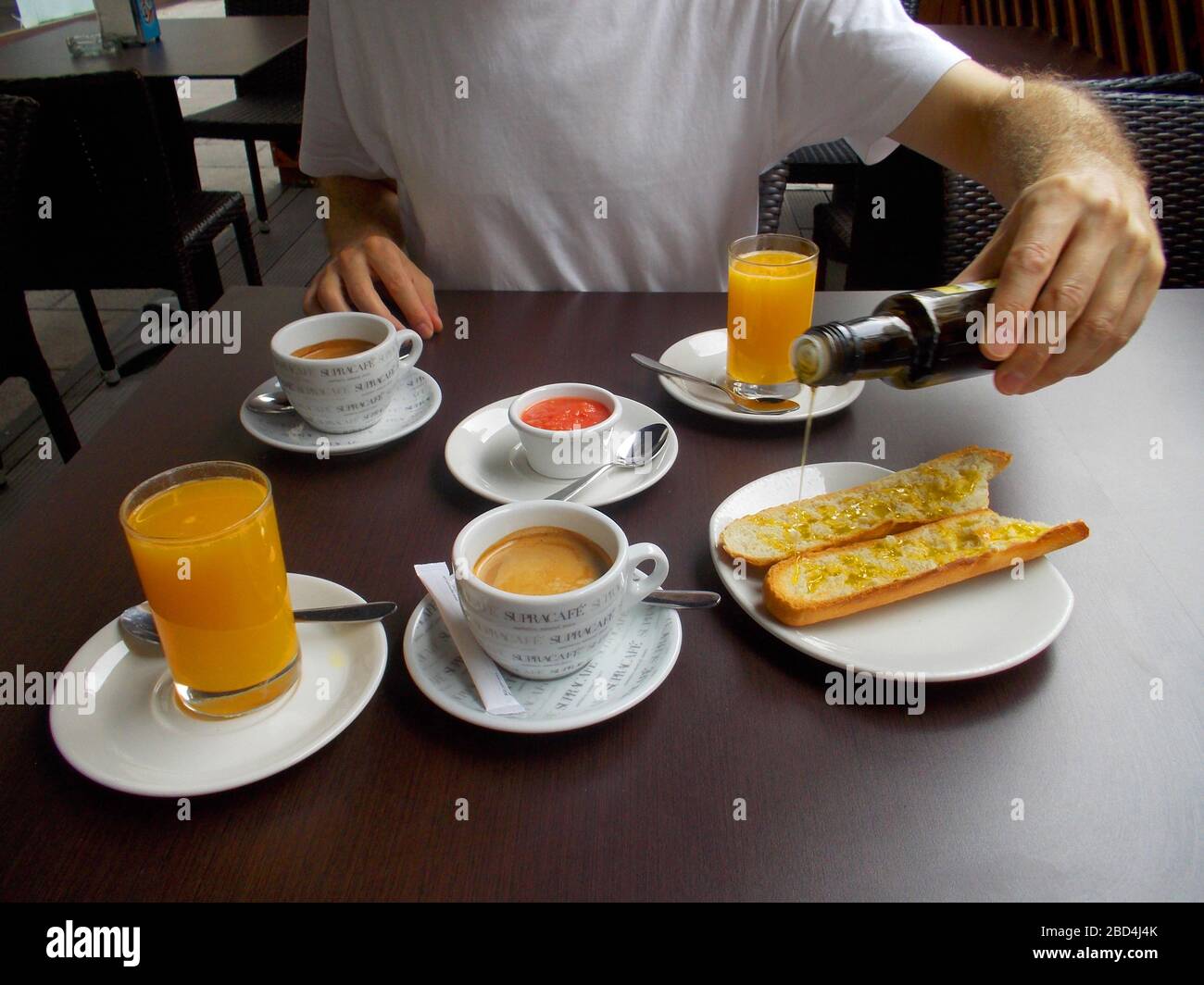 Spanish breakfast: olive oil with bread and tomato with cup of coffee. Spain. Stock Photo