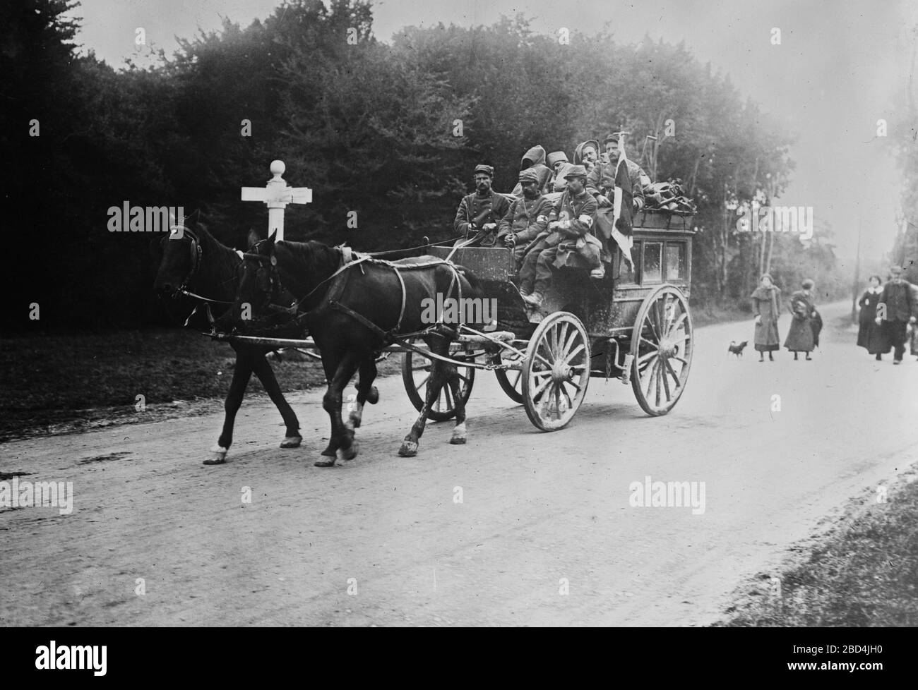 Horse-driven ambulance carrying wounded soldiers in the Forest of Laigne, France during World War I ca. 1914 Stock Photo