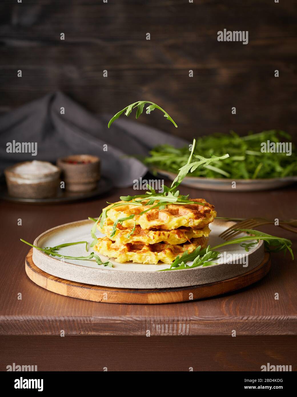 Homemade potato belgian waffles with avocado sauce, flying arugula