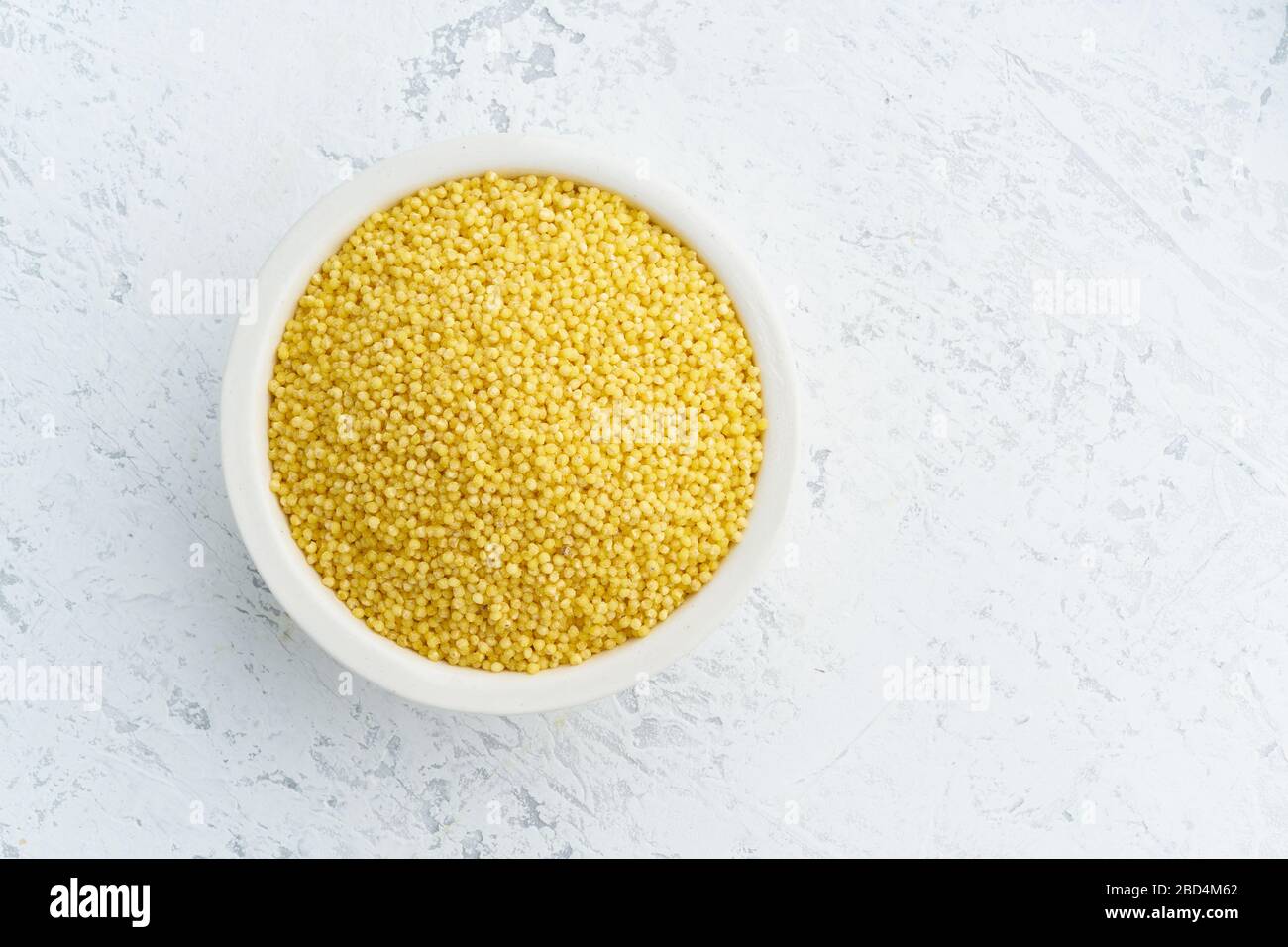 Millet, bulrush in white bowl on white background. Lectine free, dried