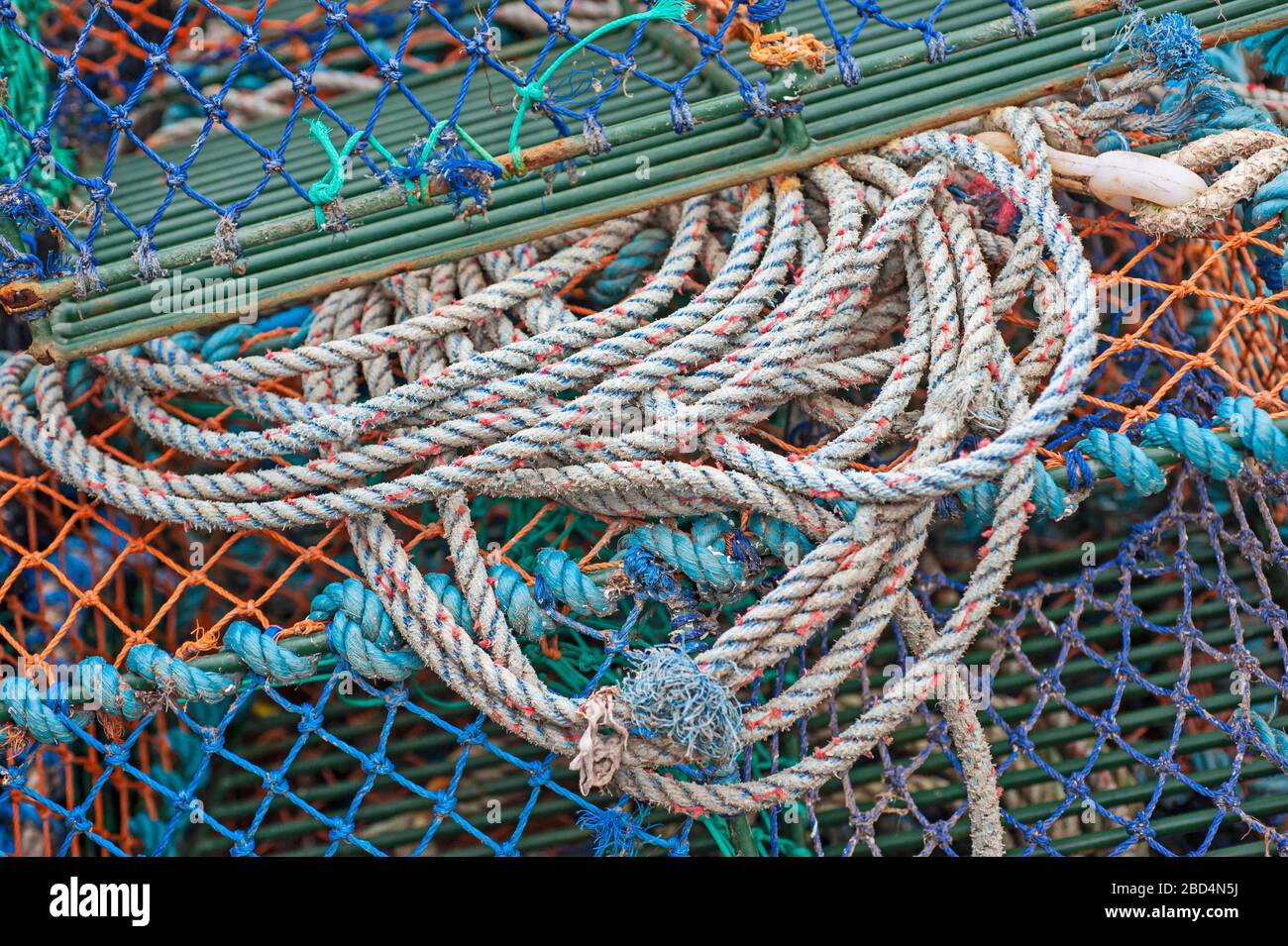 Closeup detail of lobster pots and rope on a harbor quayside Stock Photo