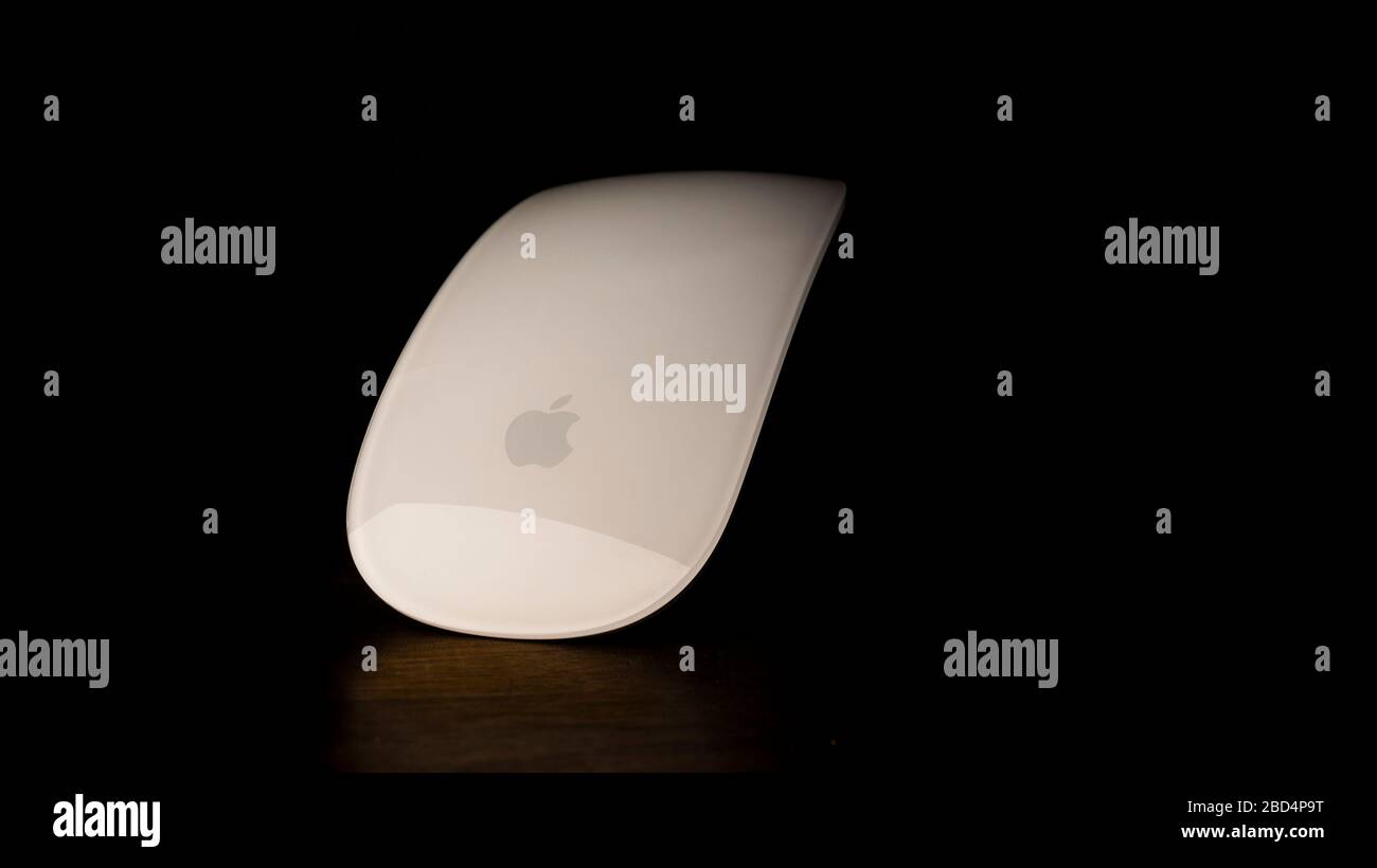 White computer mouse, set on a wooden table. Stock Photo