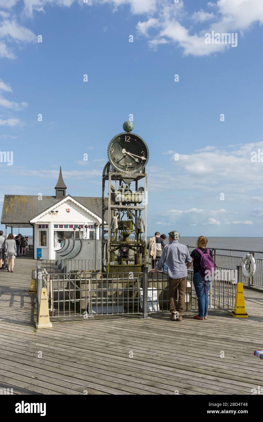 Visitors to Southwold Pier waiting for the water clock, designed by Tim