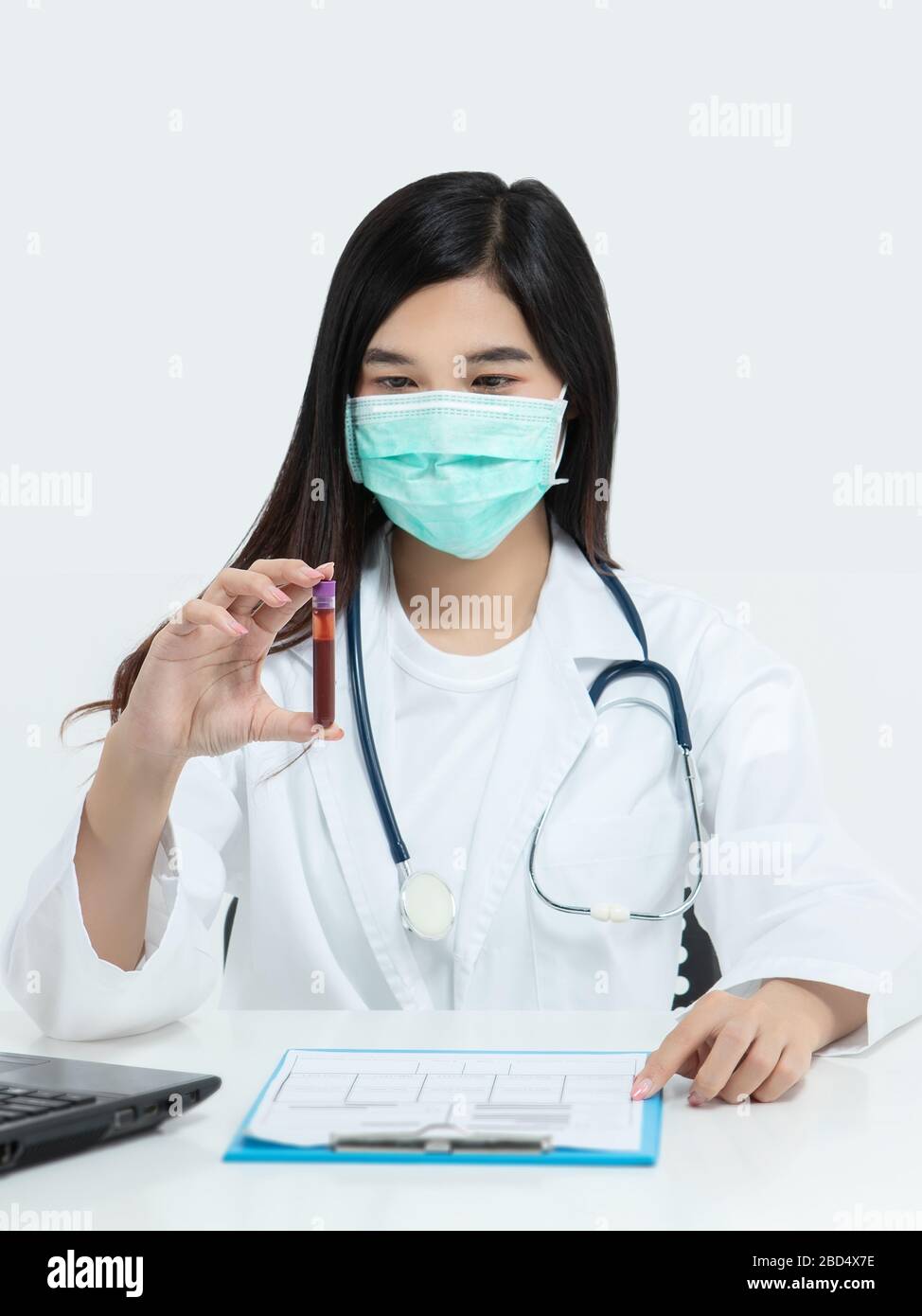 Asian doctor holding test tube with blood sample for covid-19 analyzing. laboratory analyzing for testing and invent drug and vaccine during Coronavir Stock Photo