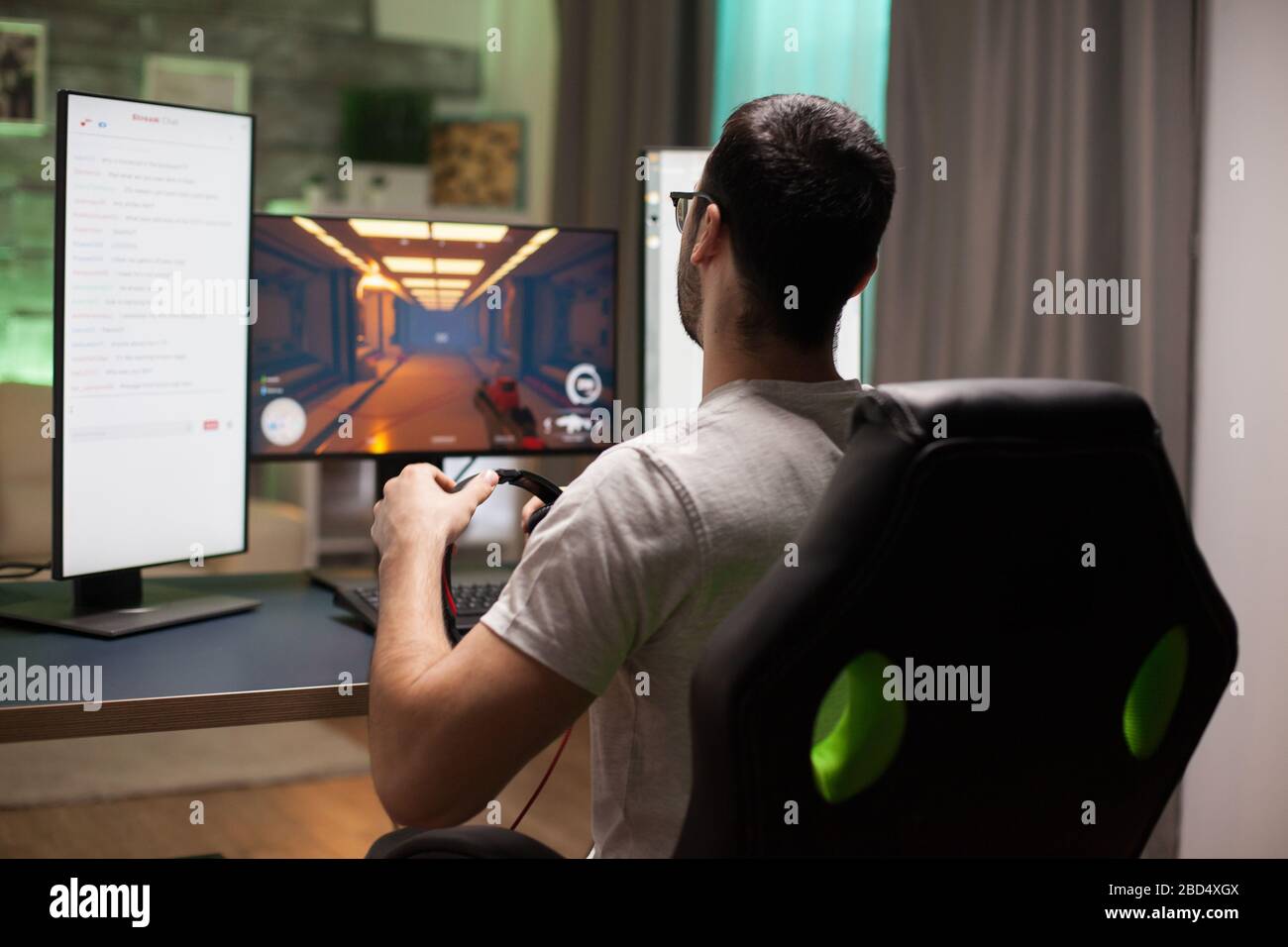 Man playing shooter games while streaming. Esports competition Stock