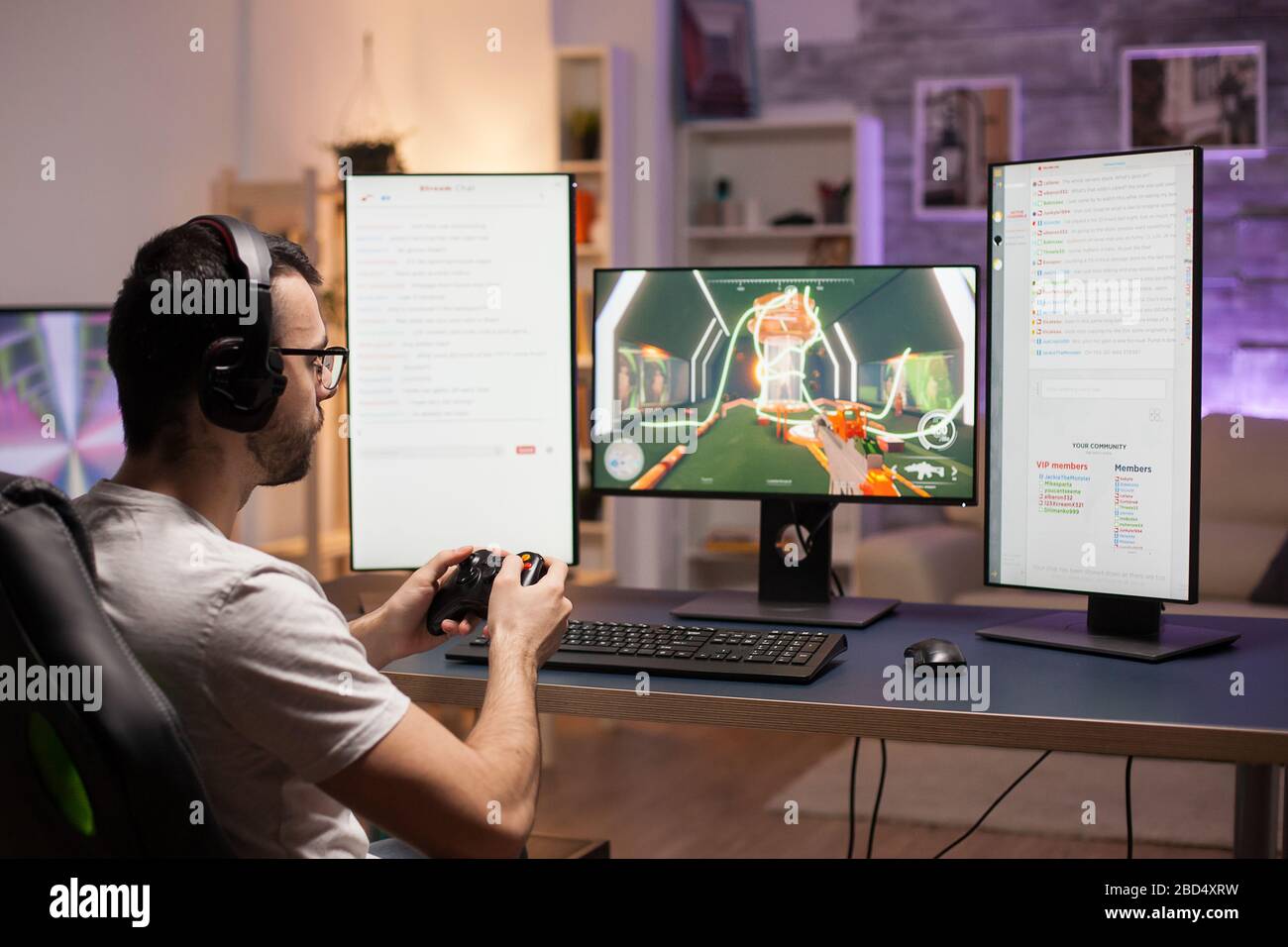 Young man with eyeglasses playing shooter games at home using wireless