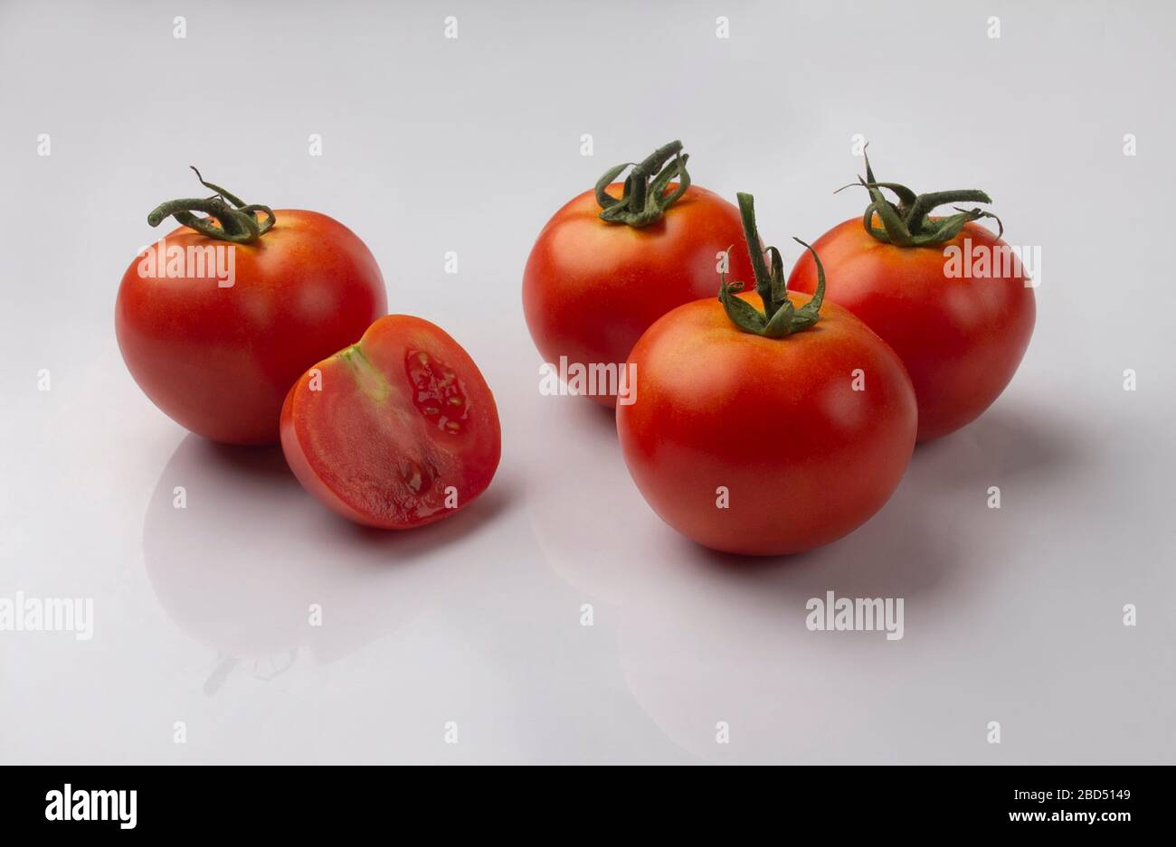 group of red tomatoes isolated on white background Stock Photo - Alamy