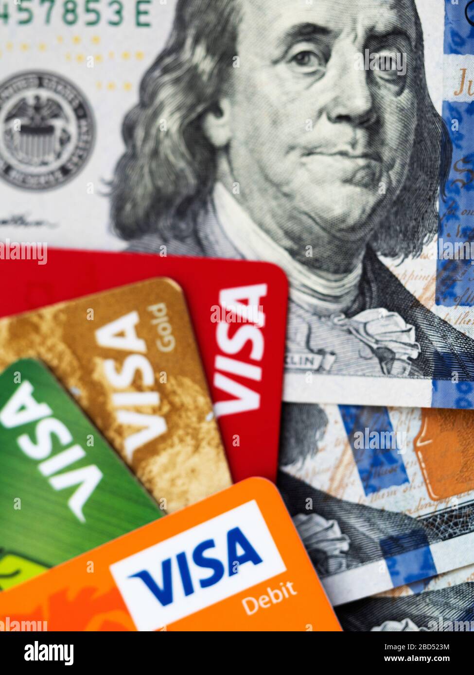 In this photoillustration is seen Visa credit cards and dollars in cash Stock Photo