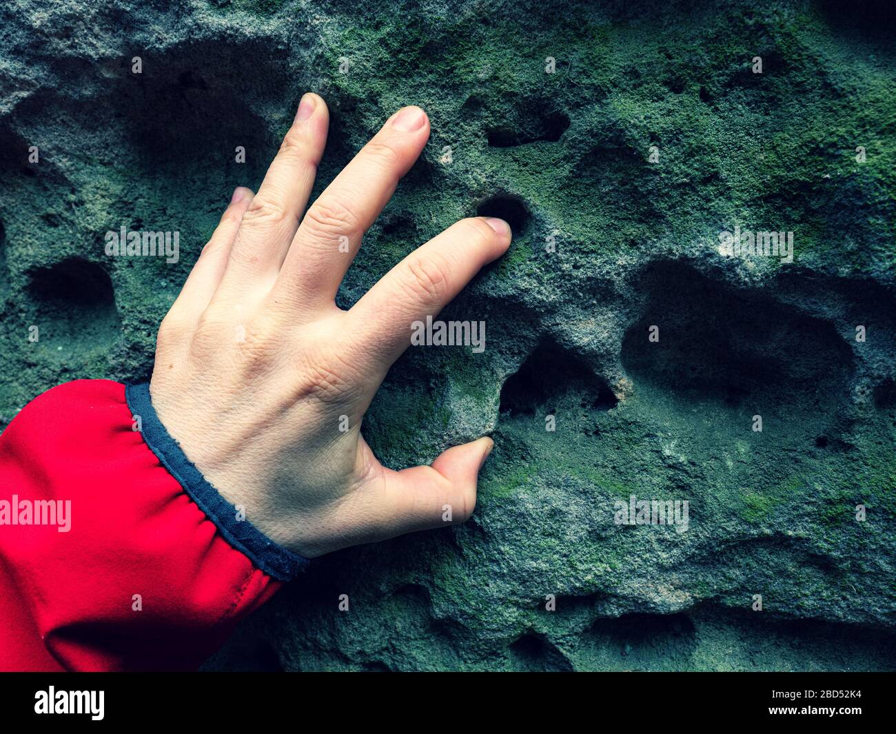 Female finger touch holes in sandstone rock. Holes called