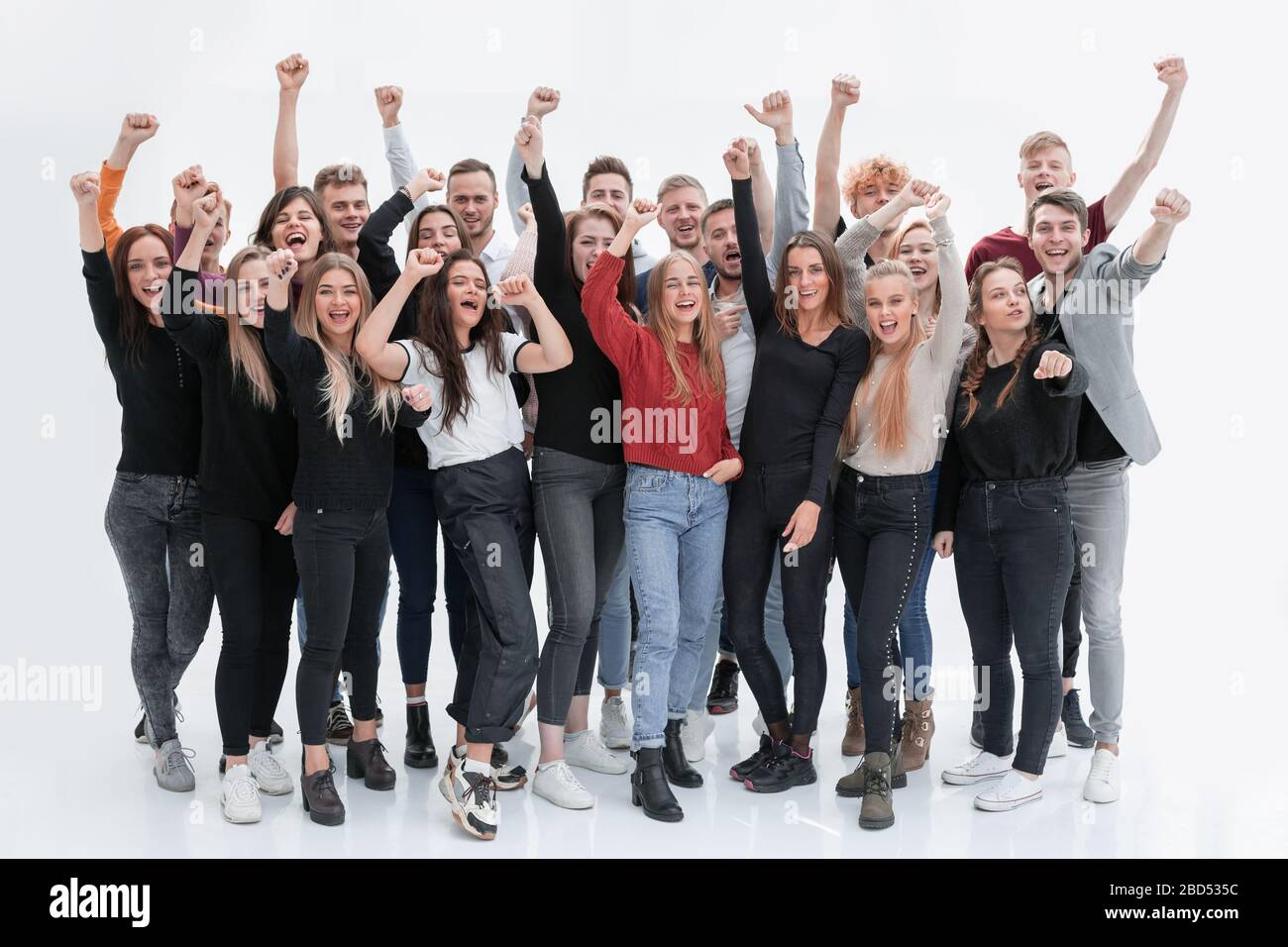 group of confident young people standing with their hands up Stock ...