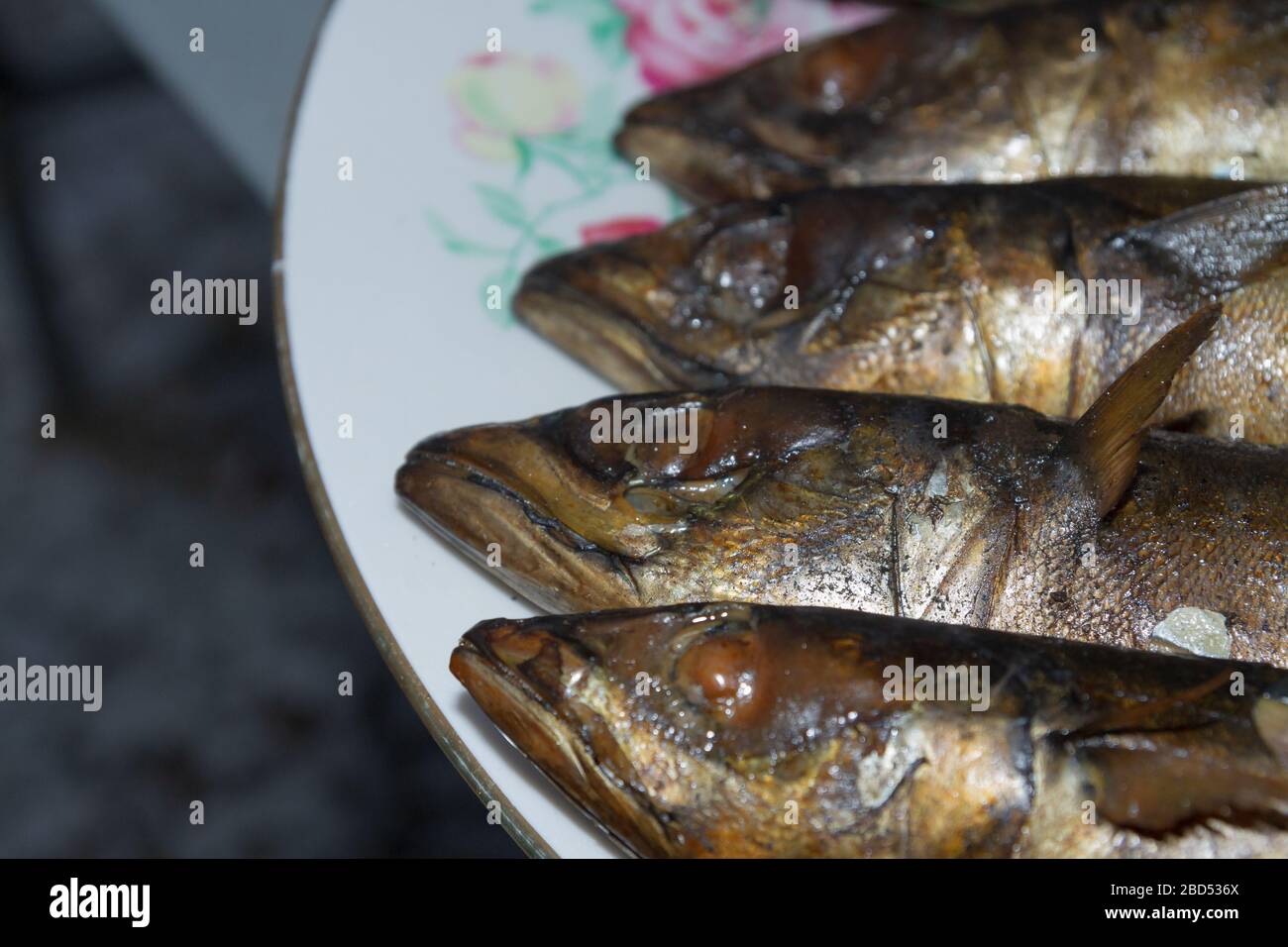 Smoked fresh fish mackerel lies hot on a ceramic plate Stock Photo