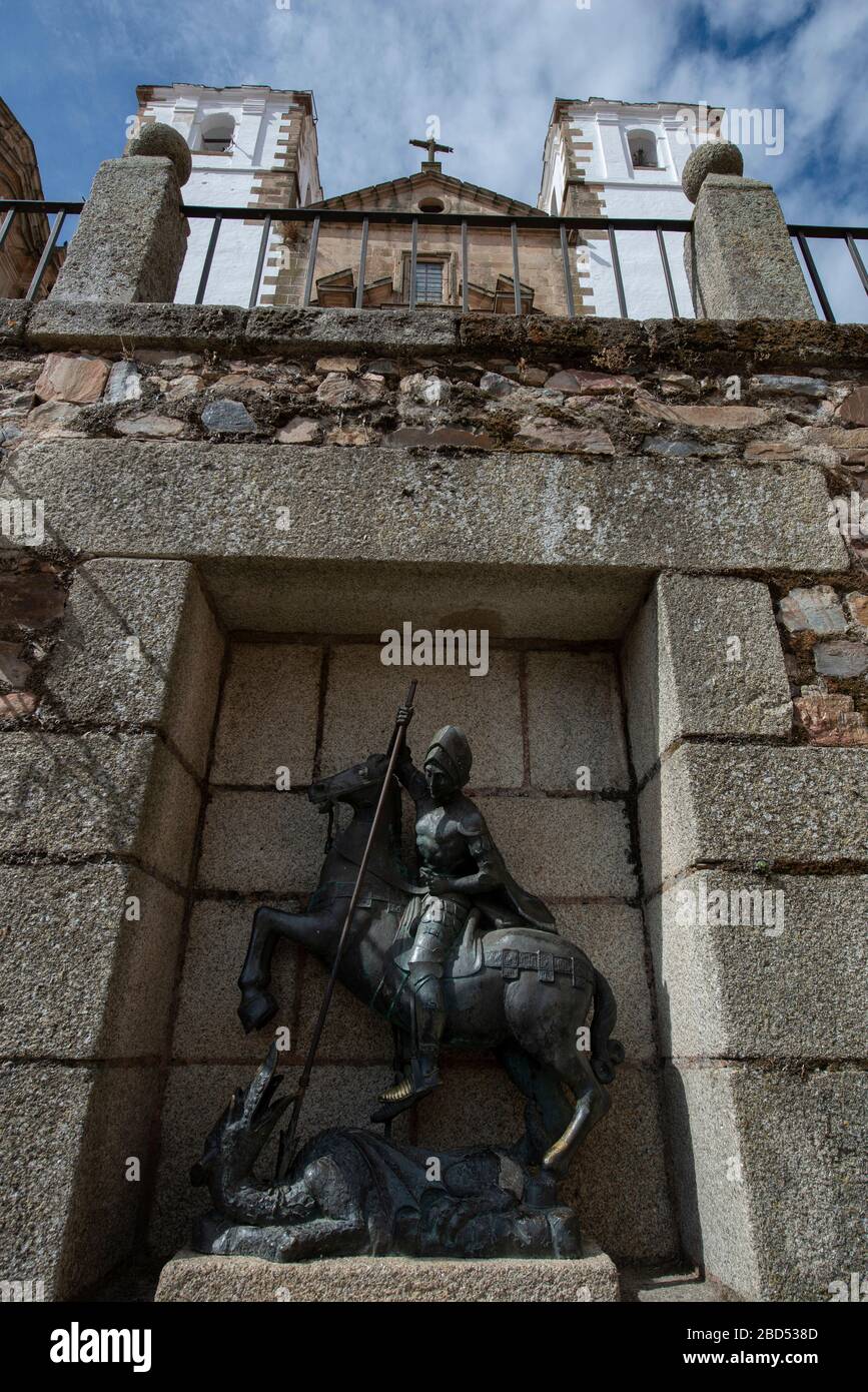Statue of St George killing the dragon with San Francisco Javier Church in background, Plaza de San Jorge, Cáceres, Extremadura, Spain, Europe Stock Photo