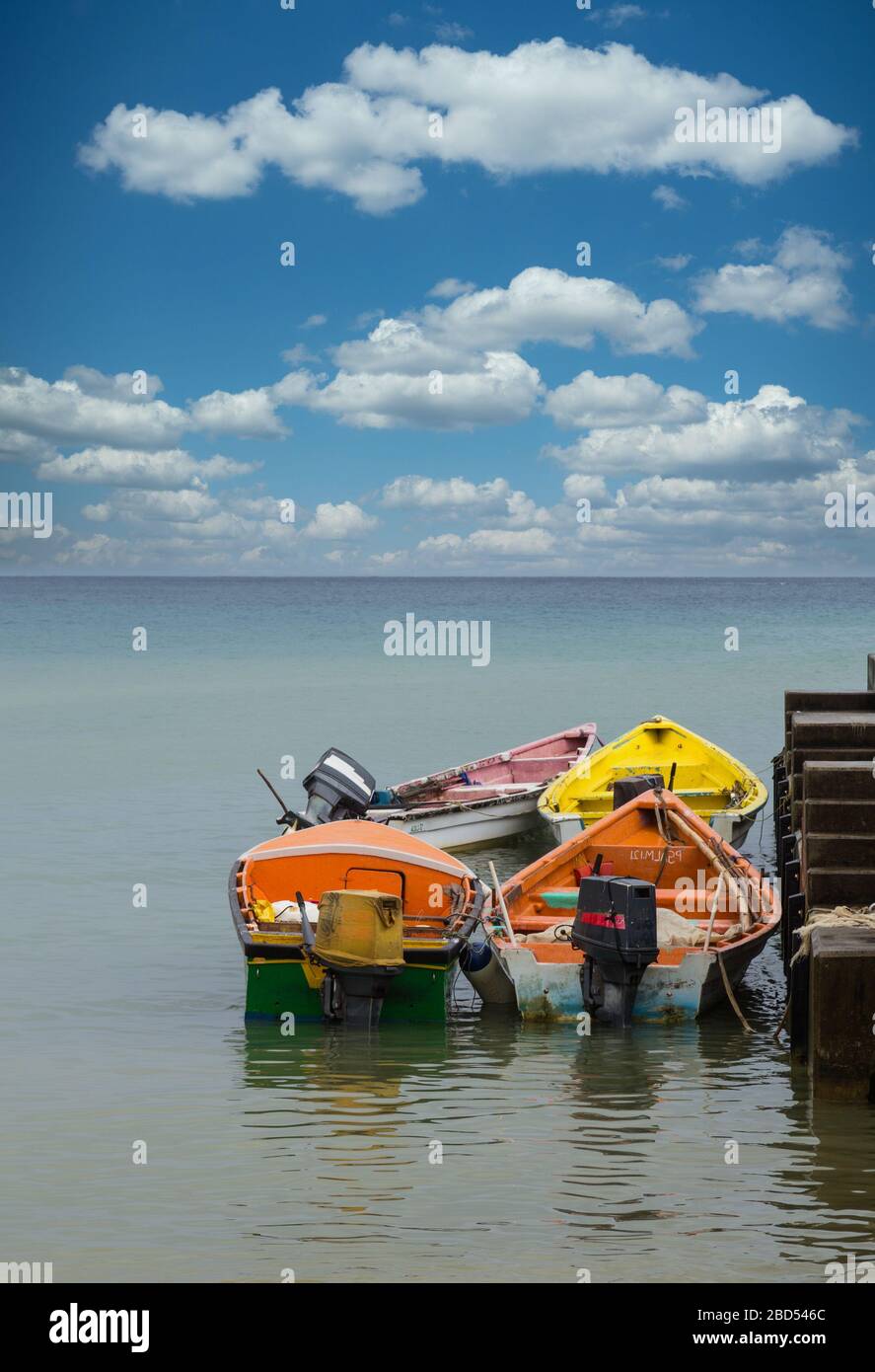 Four Colorful Fishing Boats at Pier Stock Photo