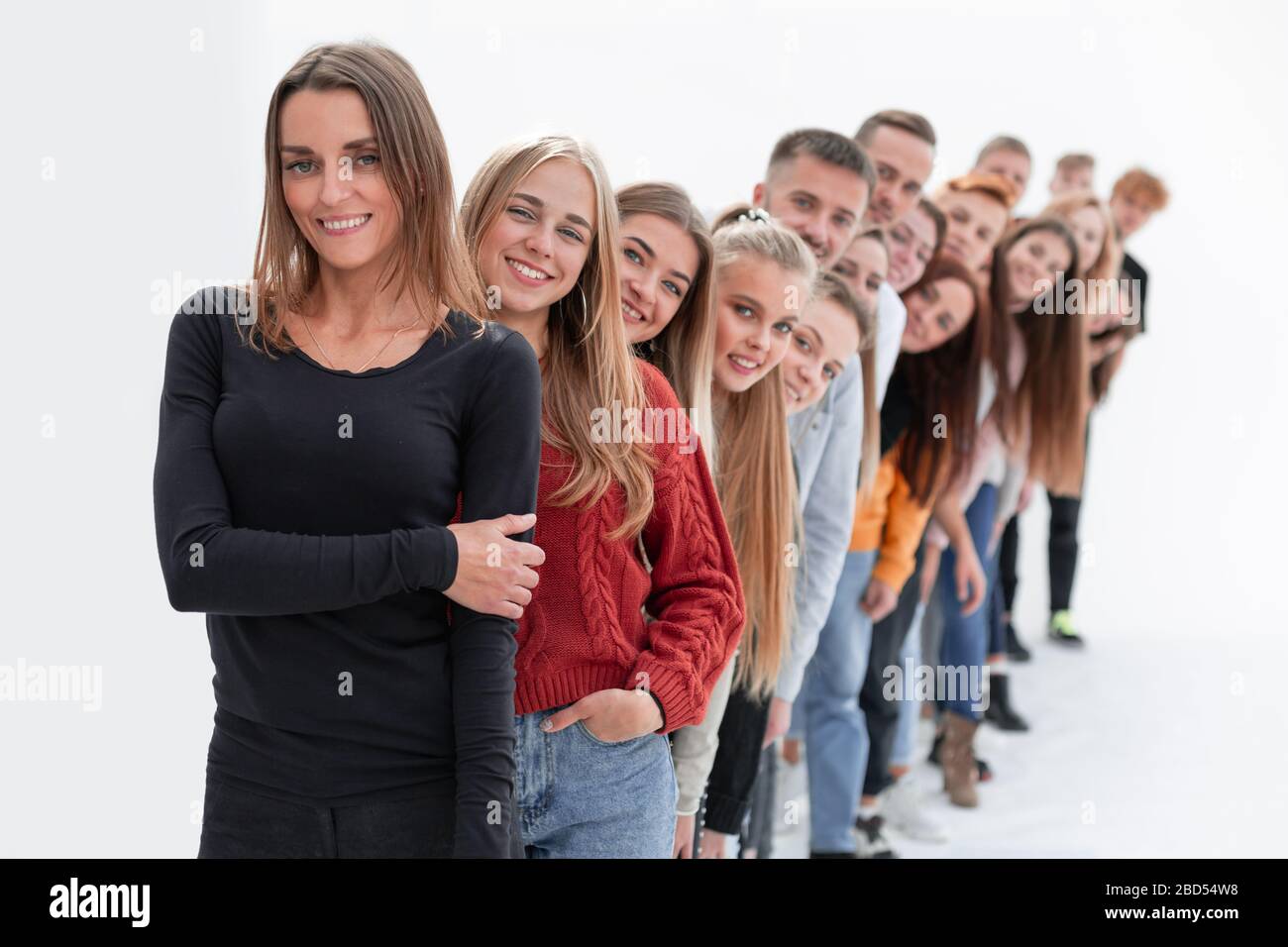 group of happy young people standing in line Stock Photo - Alamy