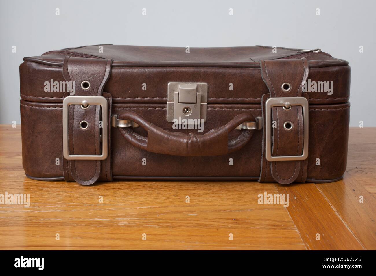 An old brown leather suitcase closed and photographed inside Stock Photo