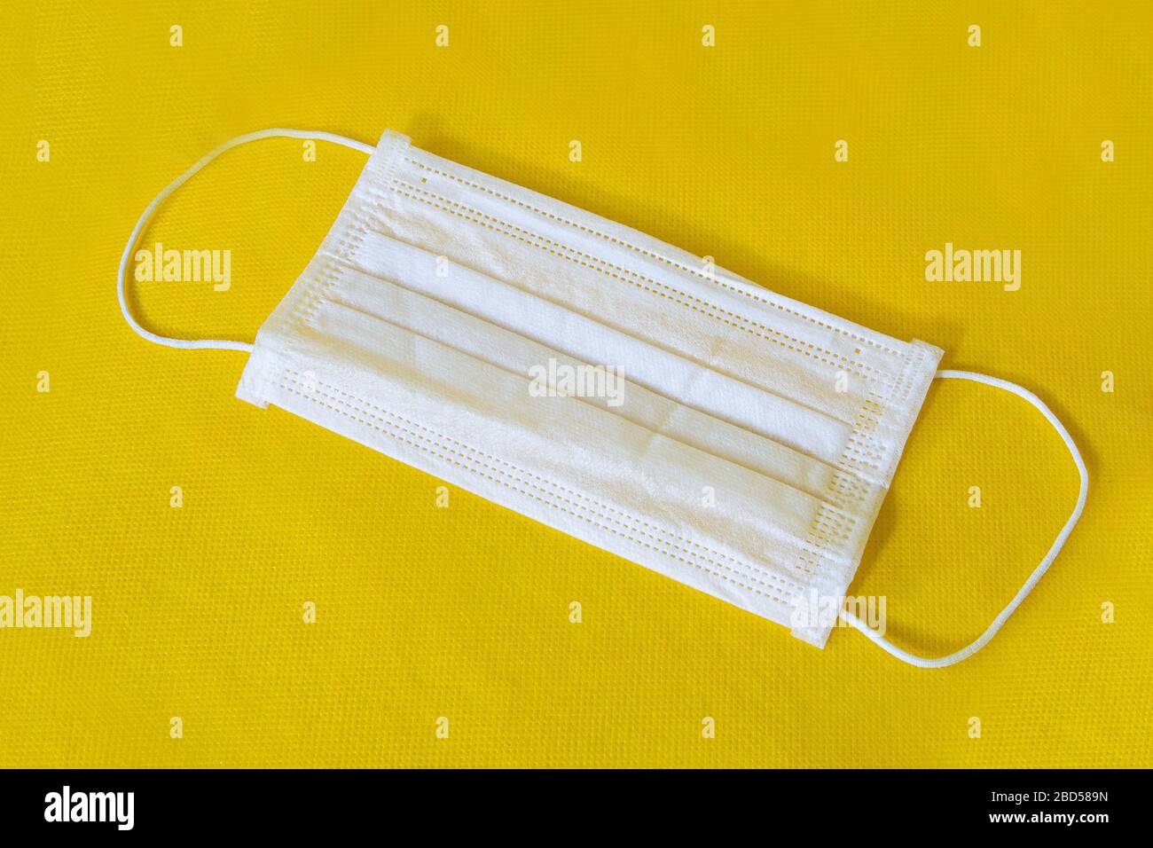 Download Surgical Mask With Rubber Ear Straps Typical 3 Ply Surgical Mask To Cover The Mouth And Nose On Yellow Background Stock Photo Alamy PSD Mockup Templates