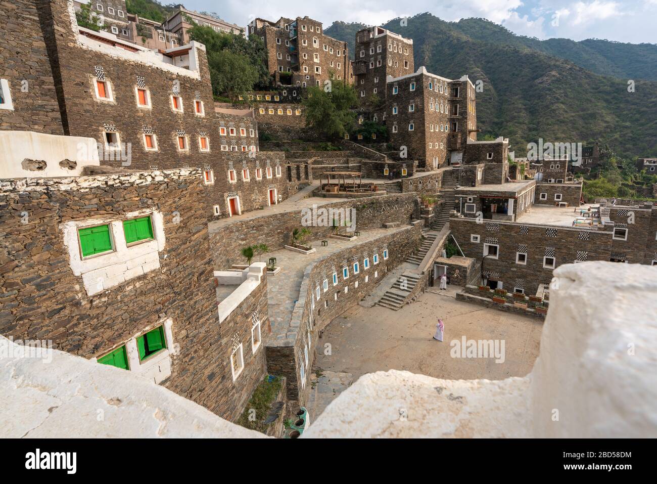 Man in traditional clothes walking at Rijal Alma historical village in Saudi Arabia Stock Photo