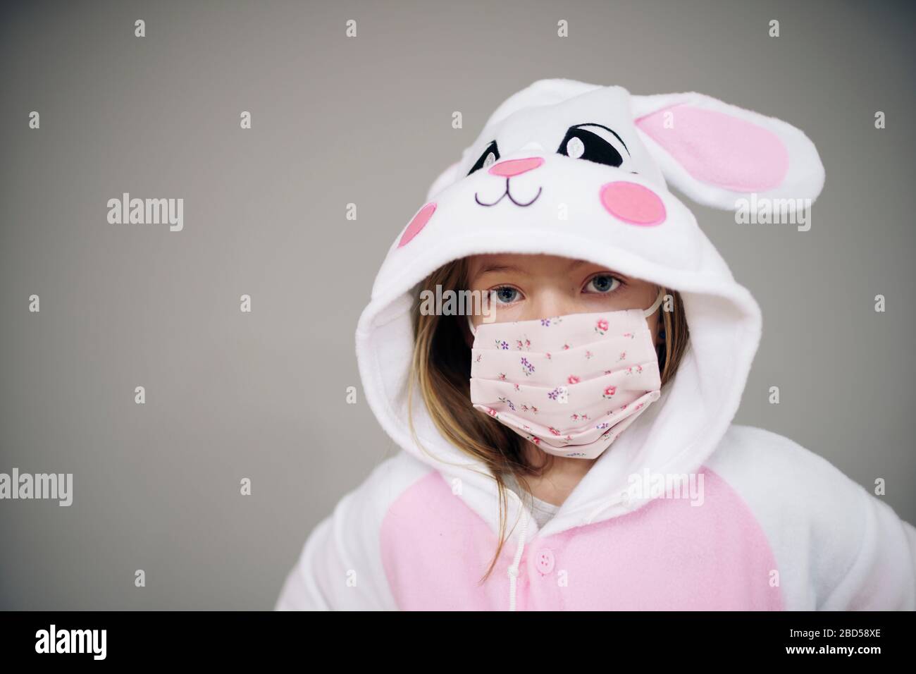 beautiful girl dressed as easter bunny rabbit with face protective mask ...