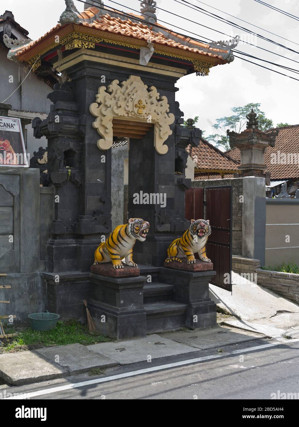 dh House compound main entrance BALI INDONESIA Balinese tiger statues entryway indonesian frontage Stock Photo