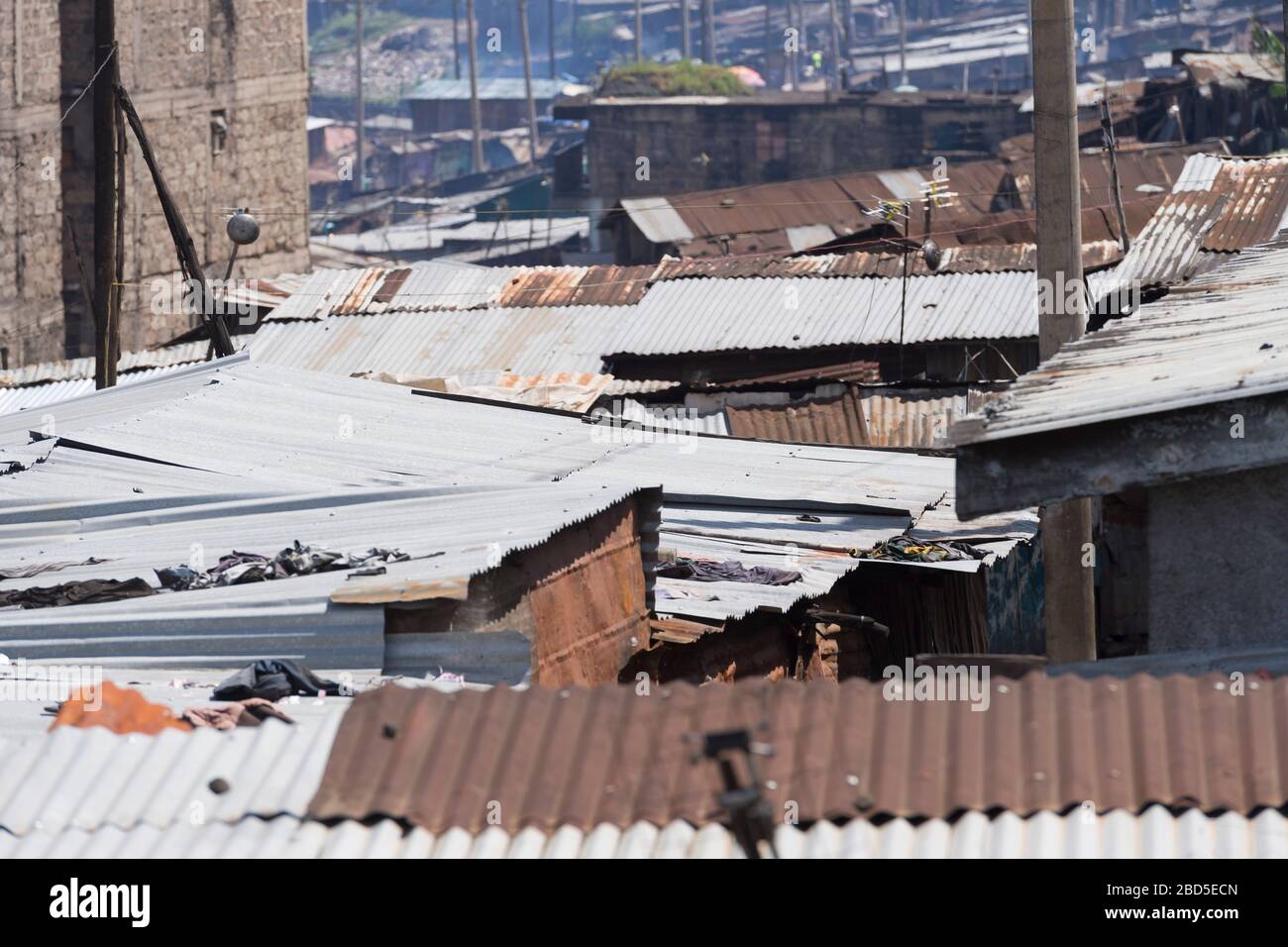A view across corrugated iron rooftops of Mathare, Nairobi, Kenya.  Mathare is a collection of slums in North East of central Nairobi, Kenya with a po Stock Photo