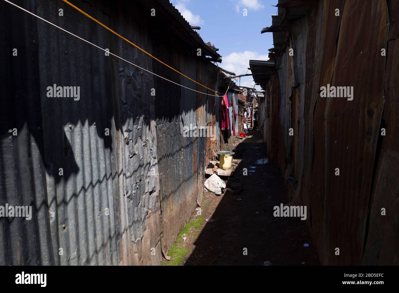 Washing hanging in an alleyway, Mathare, Nairobi, Kenya. Mathare is a ...