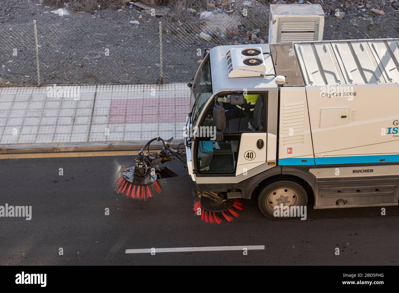 Street sweeper machine making it's way along our road, Playa San Juan, Tenerife, Canary Islands, Spain Stock Photo